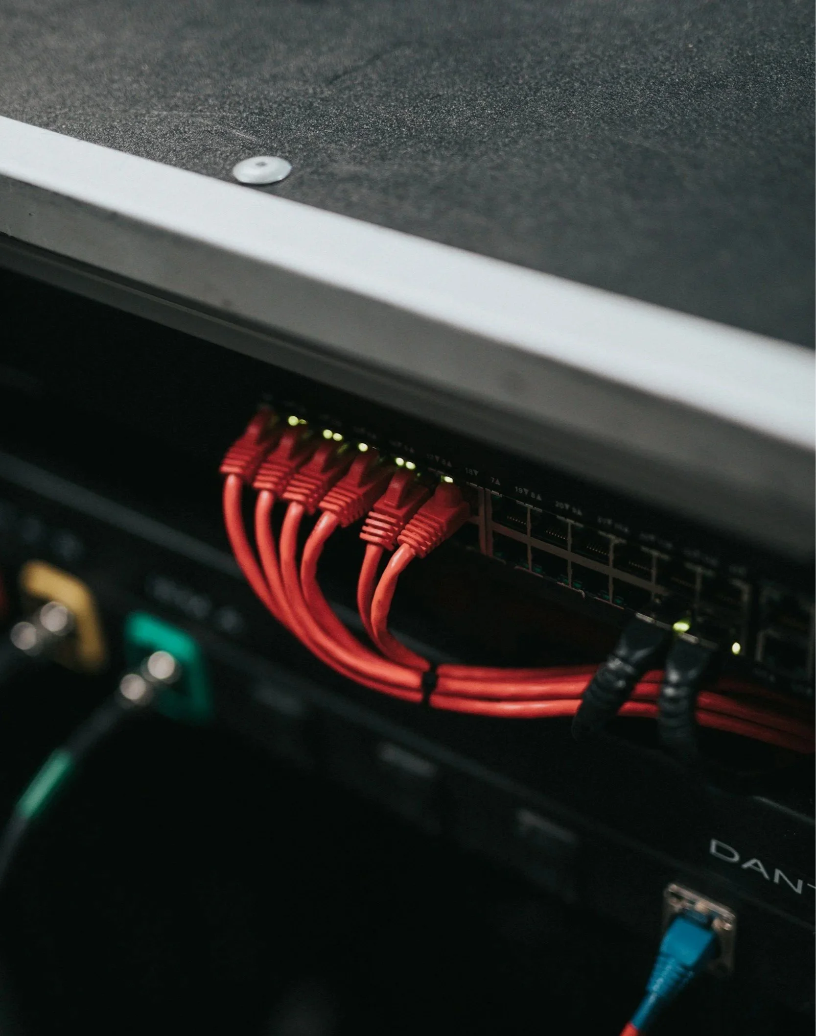 Close-up of a computer server with red cables connected to it.