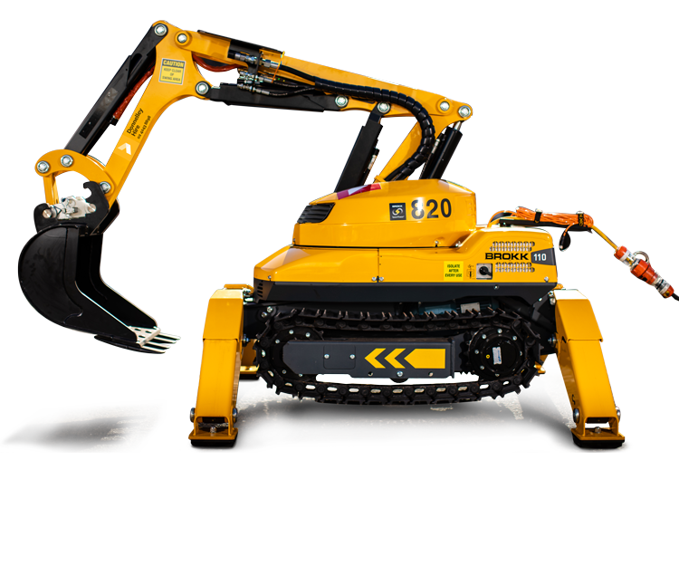 Yellow robotic construction machine with a tracked base, arm, and bucket attachment, parked outdoors on a paved surface.