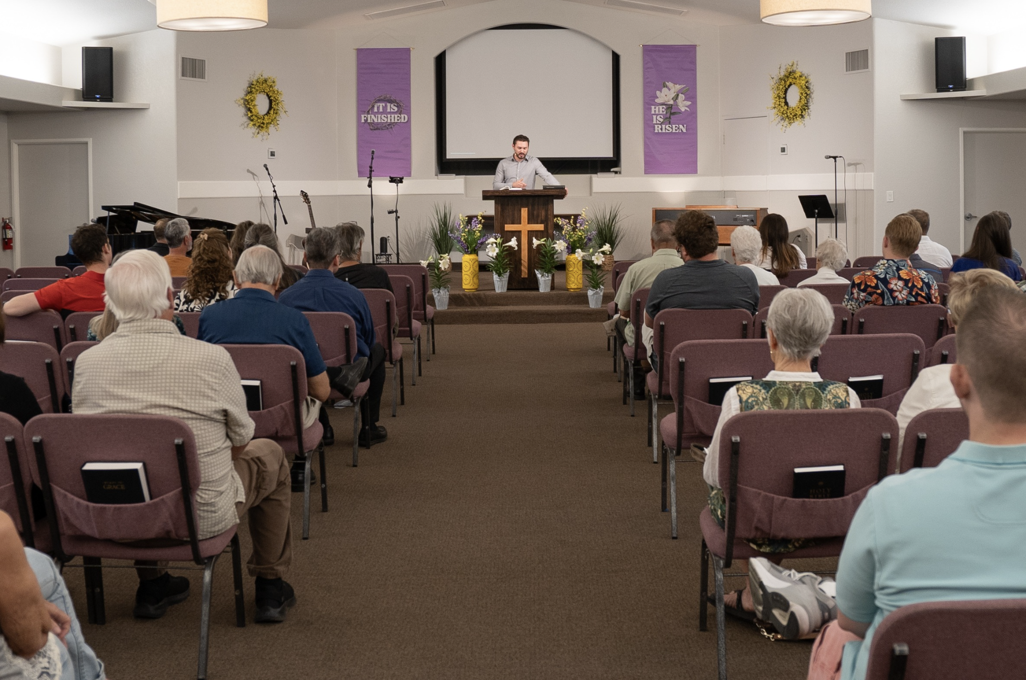 people sitting in a sanctuary during Sunday service.  