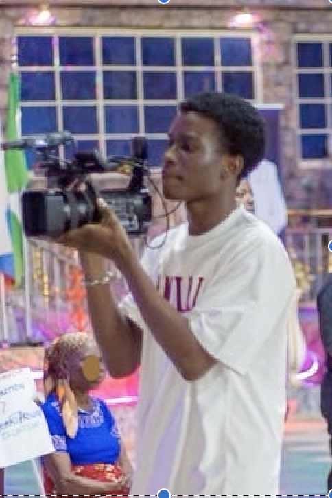 Young man recording with a video camera