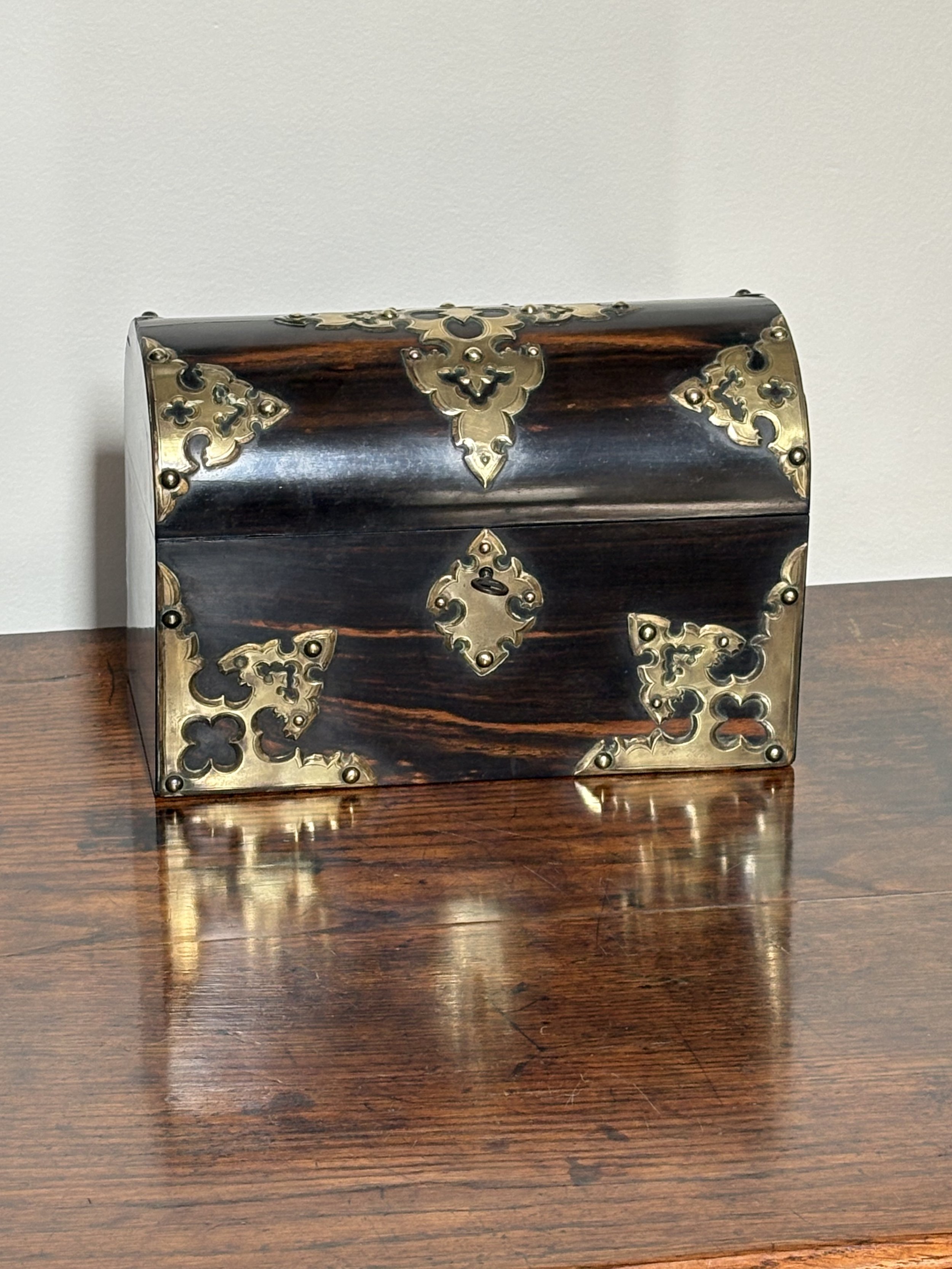 Image 1 of 3 -
Calamander Wood - a rare, exotic hardwood found predominantly in India; a near perfect moire silk interior and exquisite hand-chased brass decoration with an ecclesiastical inspiration - it’s really all a bit overwhelming.
Possibly cra