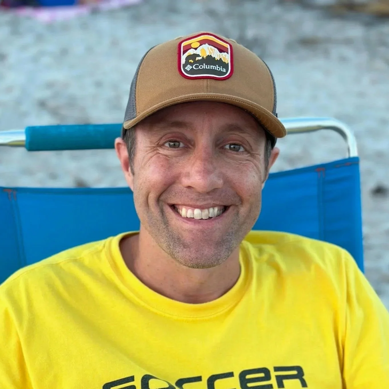 Mavericks football club logo with a black background, circular design, orange and white colors, floral element in the center, and three stars above