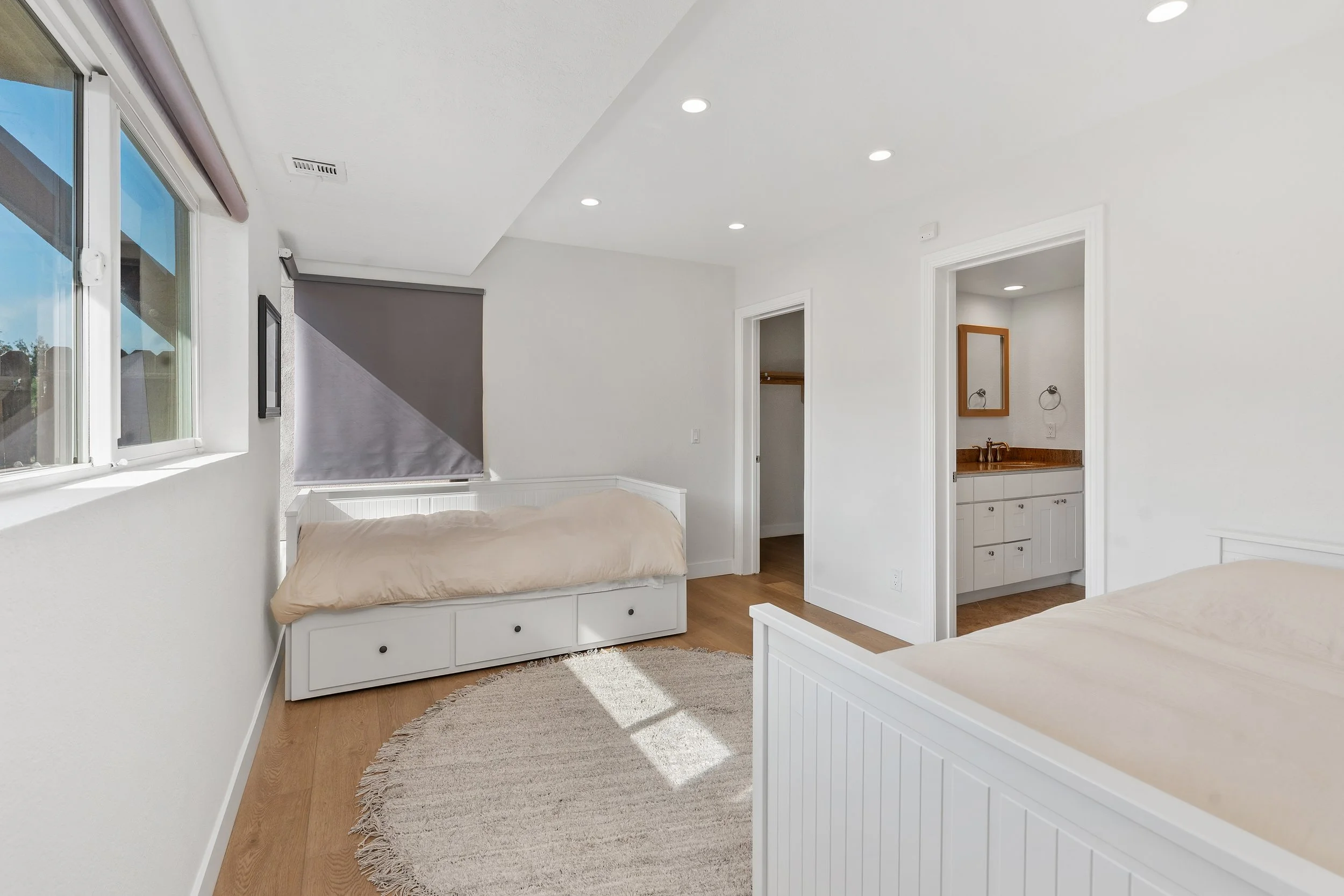 Downstairs bedroom with ensuite bathroom with dual sinks and walk-in close