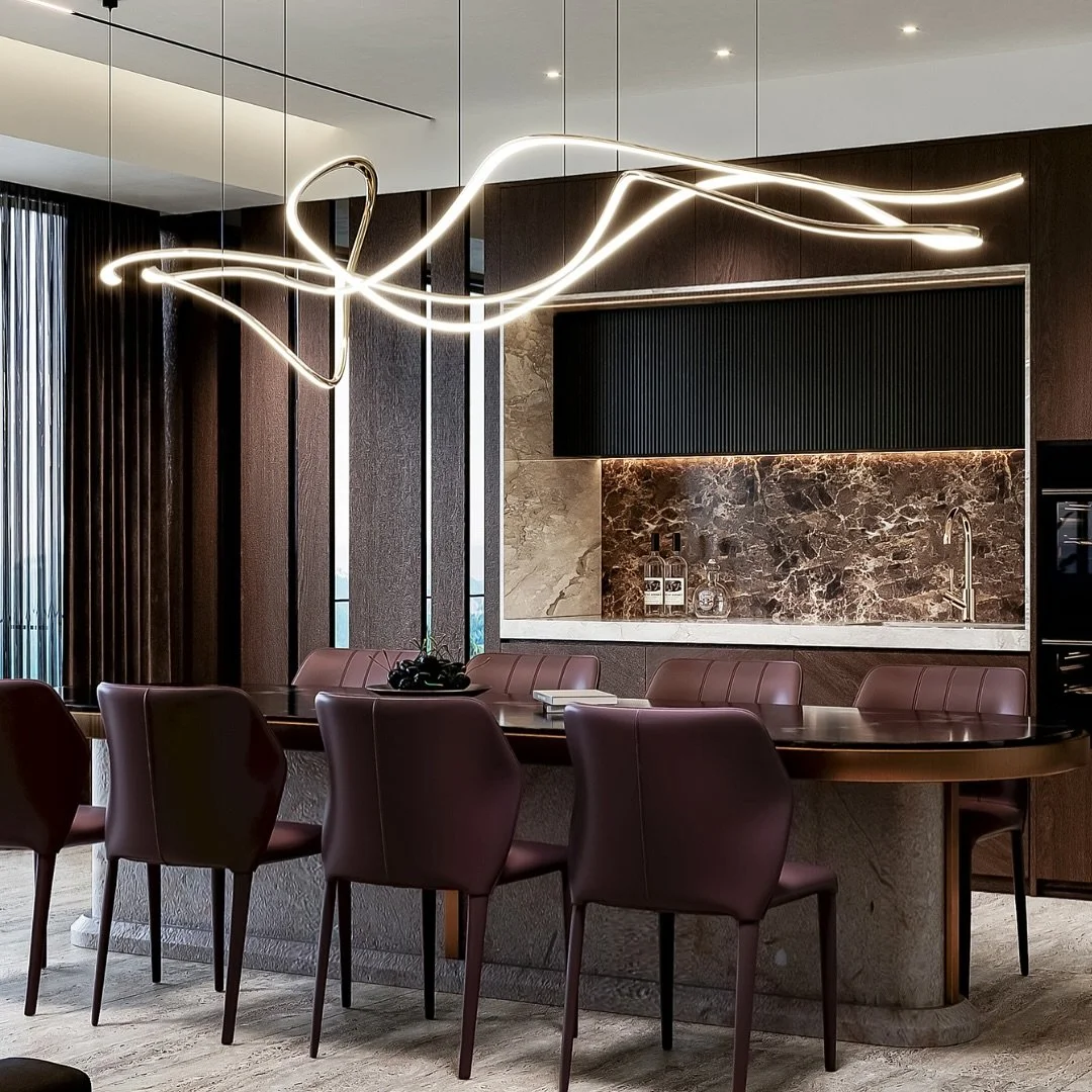 The stunning pendant light is the star of show! Centred directly above the dining table, it ties in beautifully with the wave-like pendant light in the living room.

Dark timber cabinetry acts as a backdrop to the beautiful plum tones of the dining c
