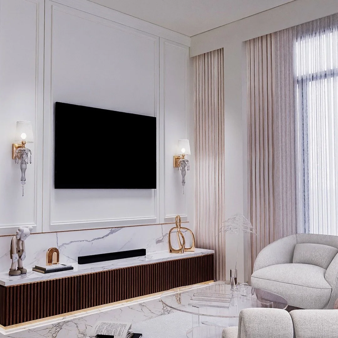 Mirroring the dining room, this elegant living room oozes class and sophistication. The grey linen sofa adds to the neutrality of the room, whilst the wall lamps add a sense of individuality.

The marble flooring and TV console, along with the gold t