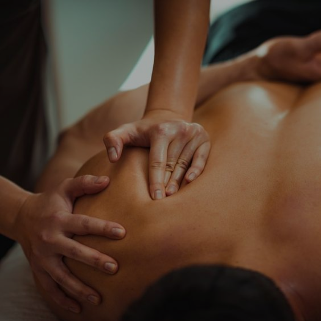 zoom shot of massage therapist working on shoulder blade