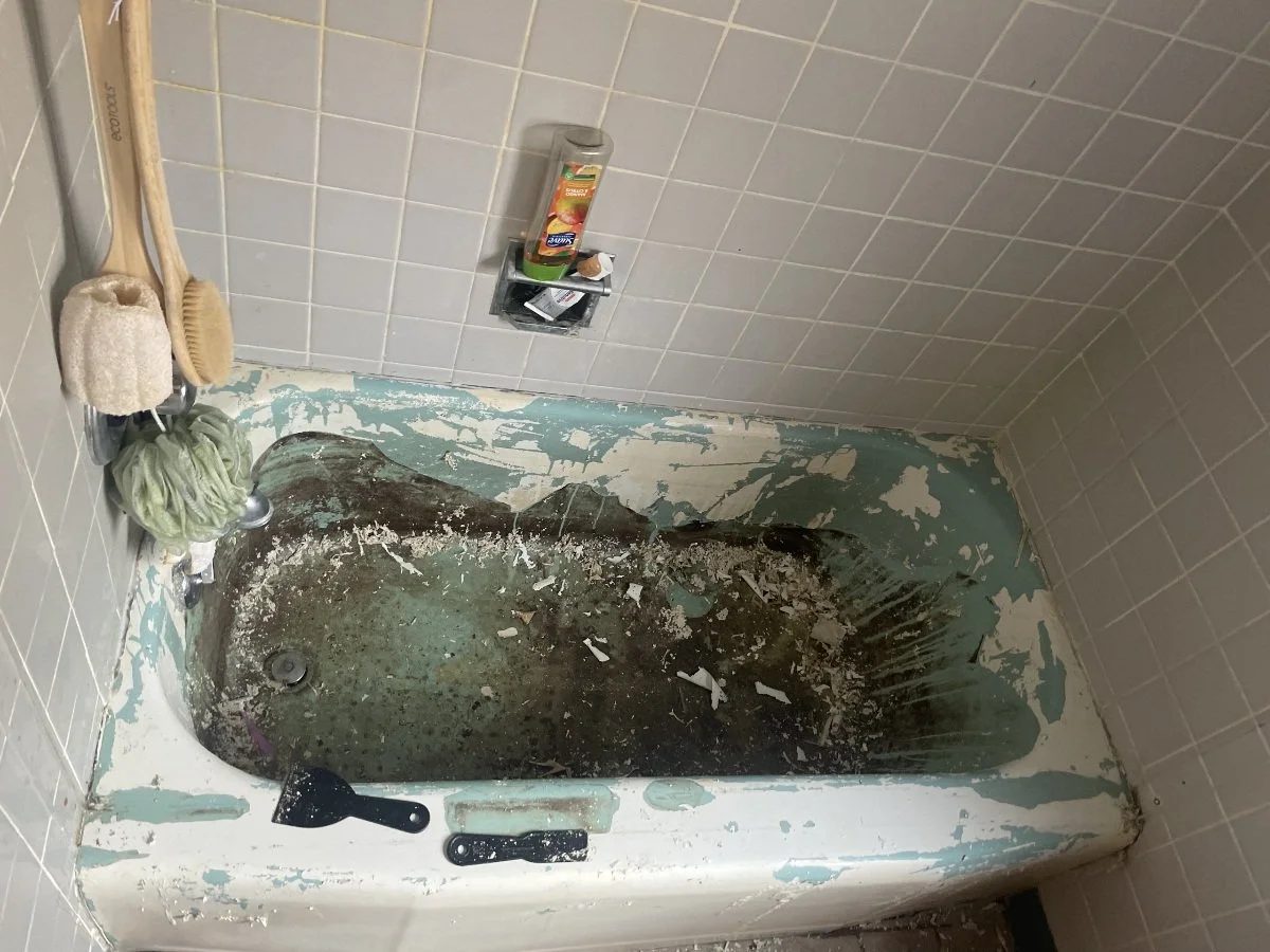 Beginning process of removing old, chipped paint to clean refinished bathtub