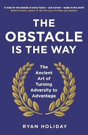 Book cover titled 'The Obstacle is the Way' by Ryan Holiday with a blue background and gold laurel wreath.
