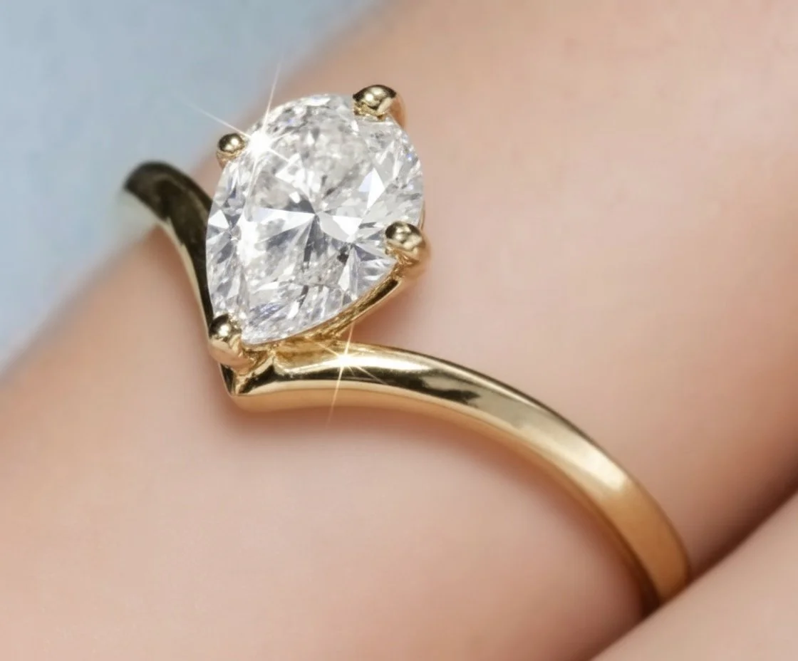 Close-up of a gold ring with a large, sparkling, heart-shaped diamond.