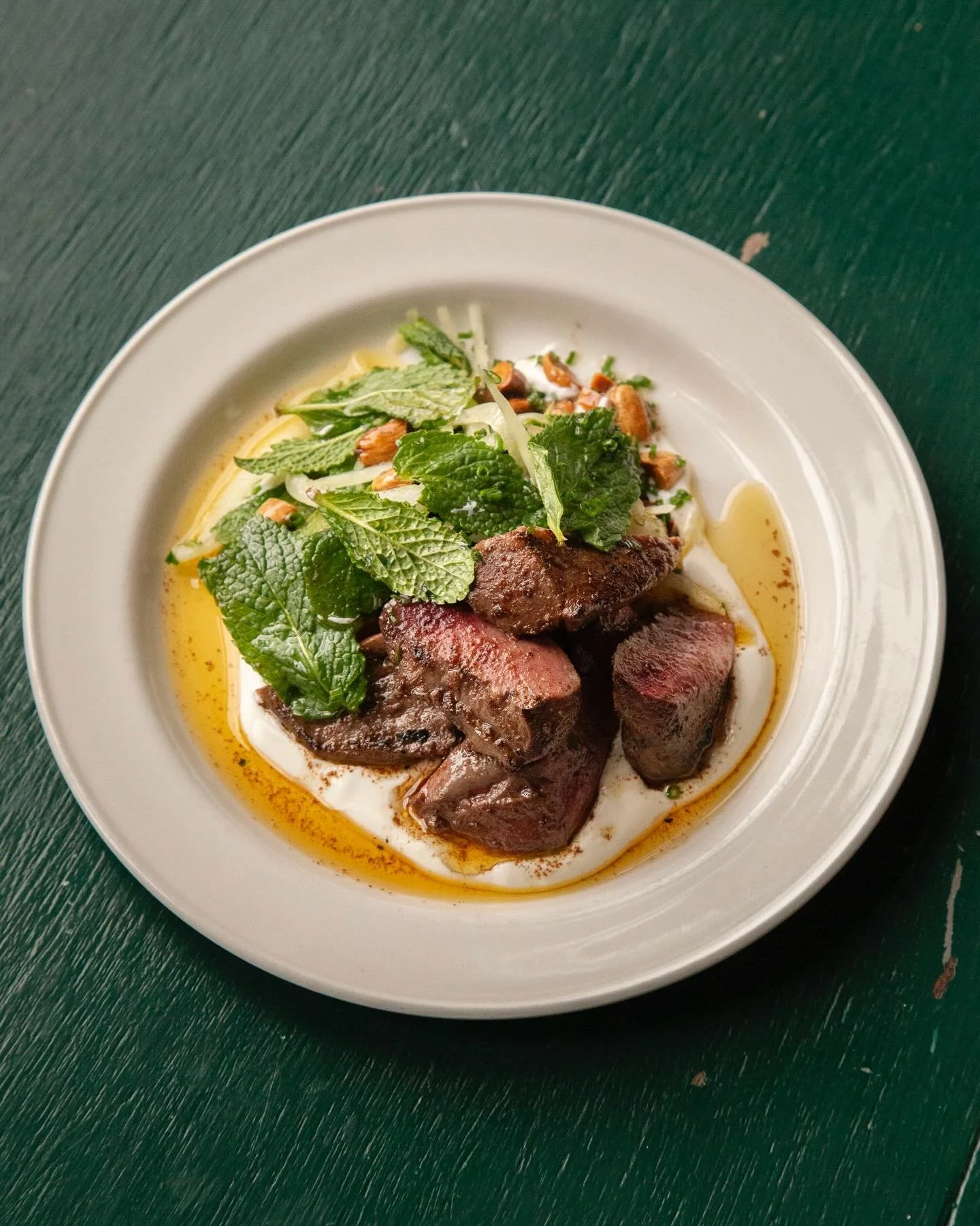 Devilled lamb heart with mint, almonds and yoghurt. We&rsquo;re firm believers in using the whole animal and heart is a great intro to offal - essentially a muscle it isn&rsquo;t far in flavour from the rest of the meat from the beast. We devil them 