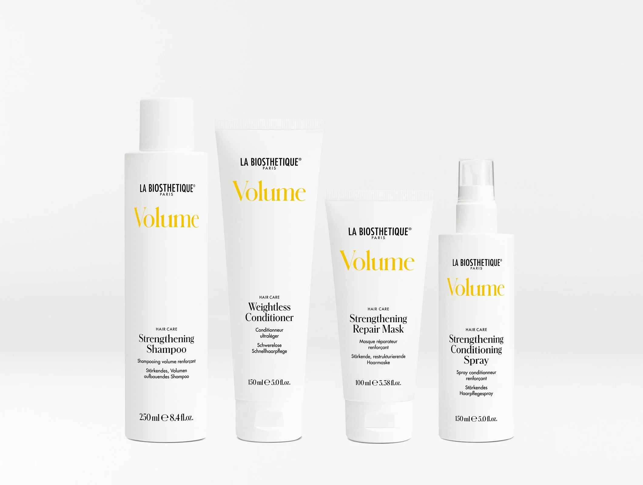 verschiedene Haarpflegeprodukte der Marke La Biosthetique, darunter Shampoo, Conditioner, Haarkur und Haarspray, in weißen Verpackungen mit schwarzer und gelber Beschriftung