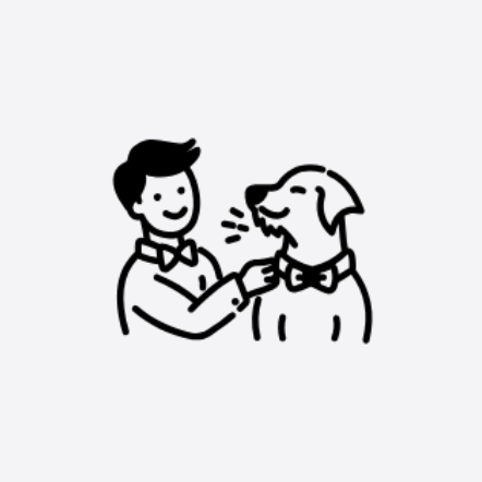 A person smiling and adjusting a bow tie on a dog, both appearing happy.