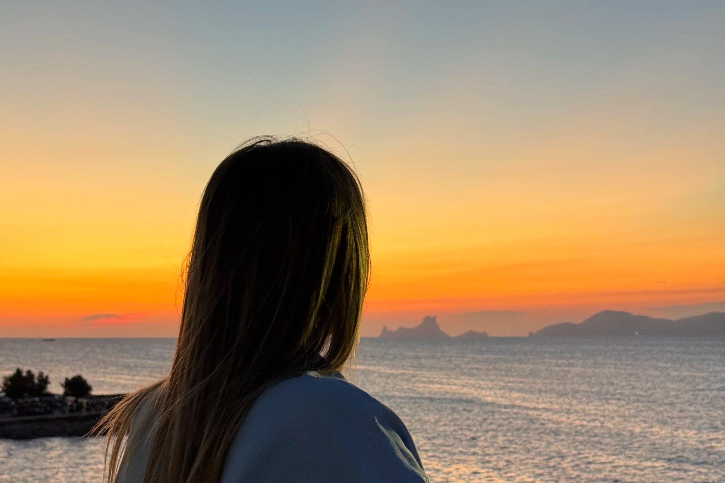 young woman looking out into the sunset stuck in the adhd grief cycle