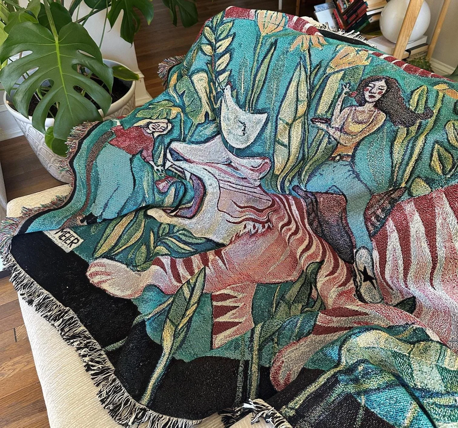 Large tapestry featuring a tiger, roommates, and plants in a vibrant painting.