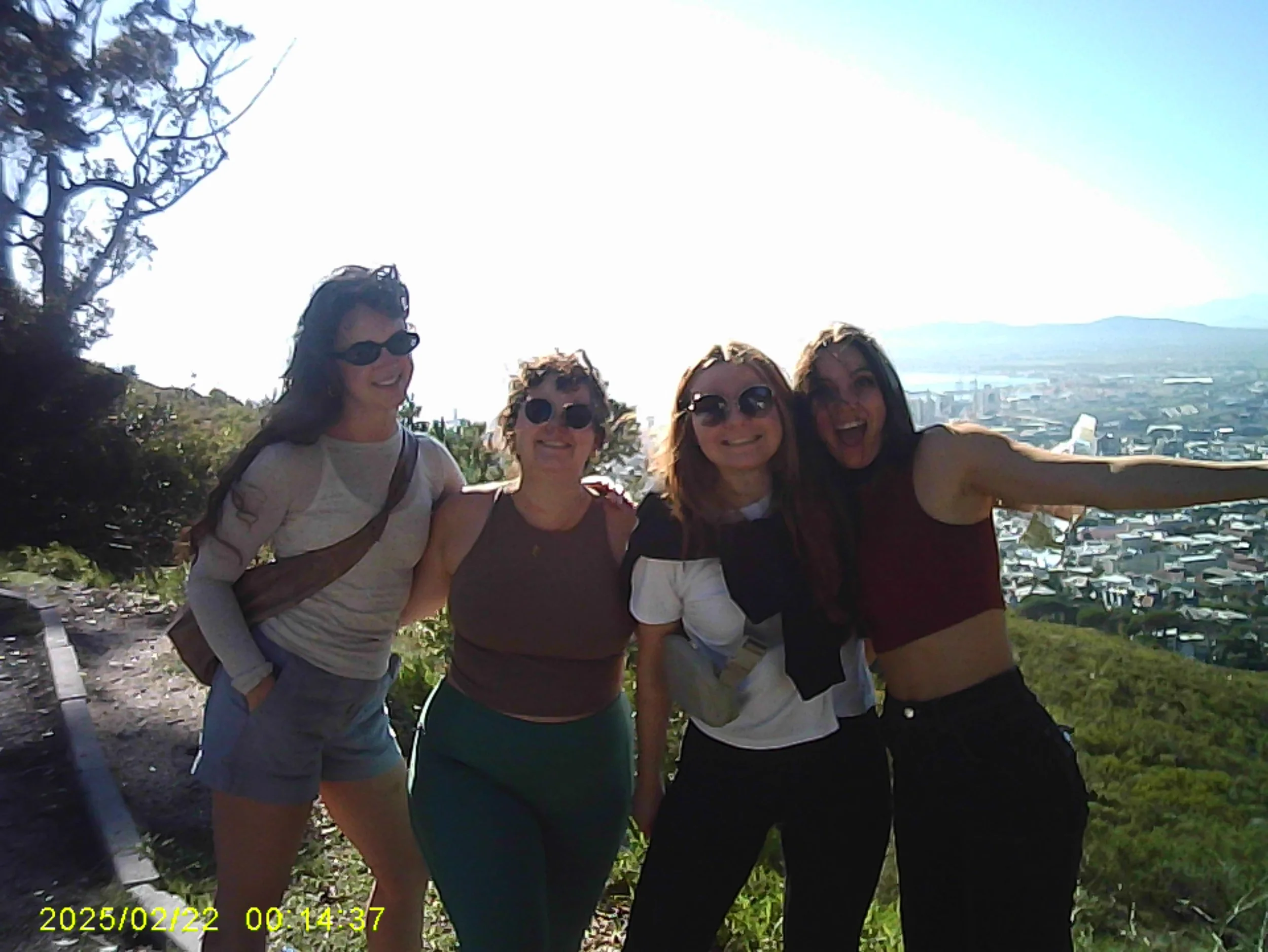 “Erin with her girlfriends, arms around each other, laughing.”