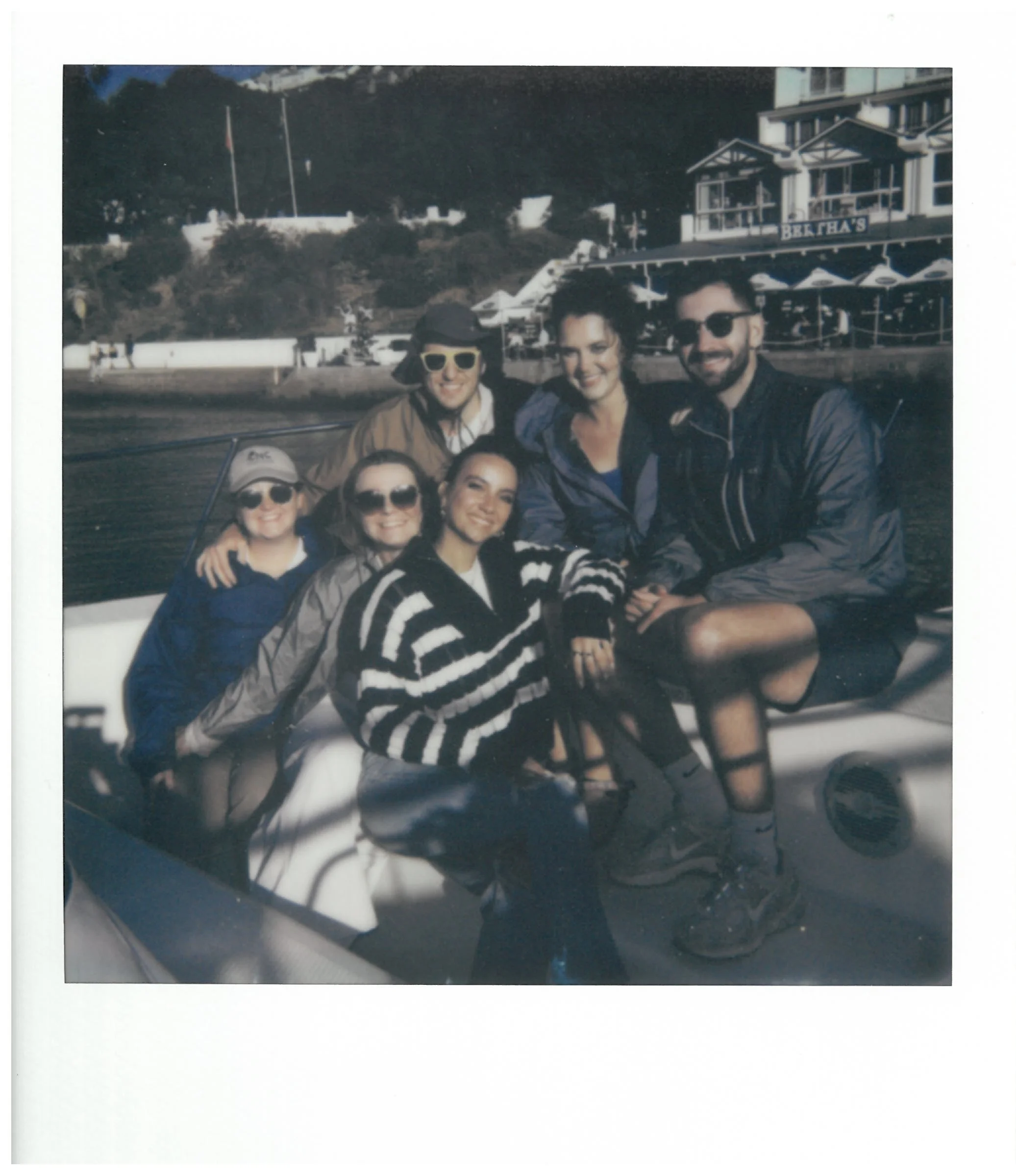“Vintage-style Polaroid of Erin with a group of friends.”