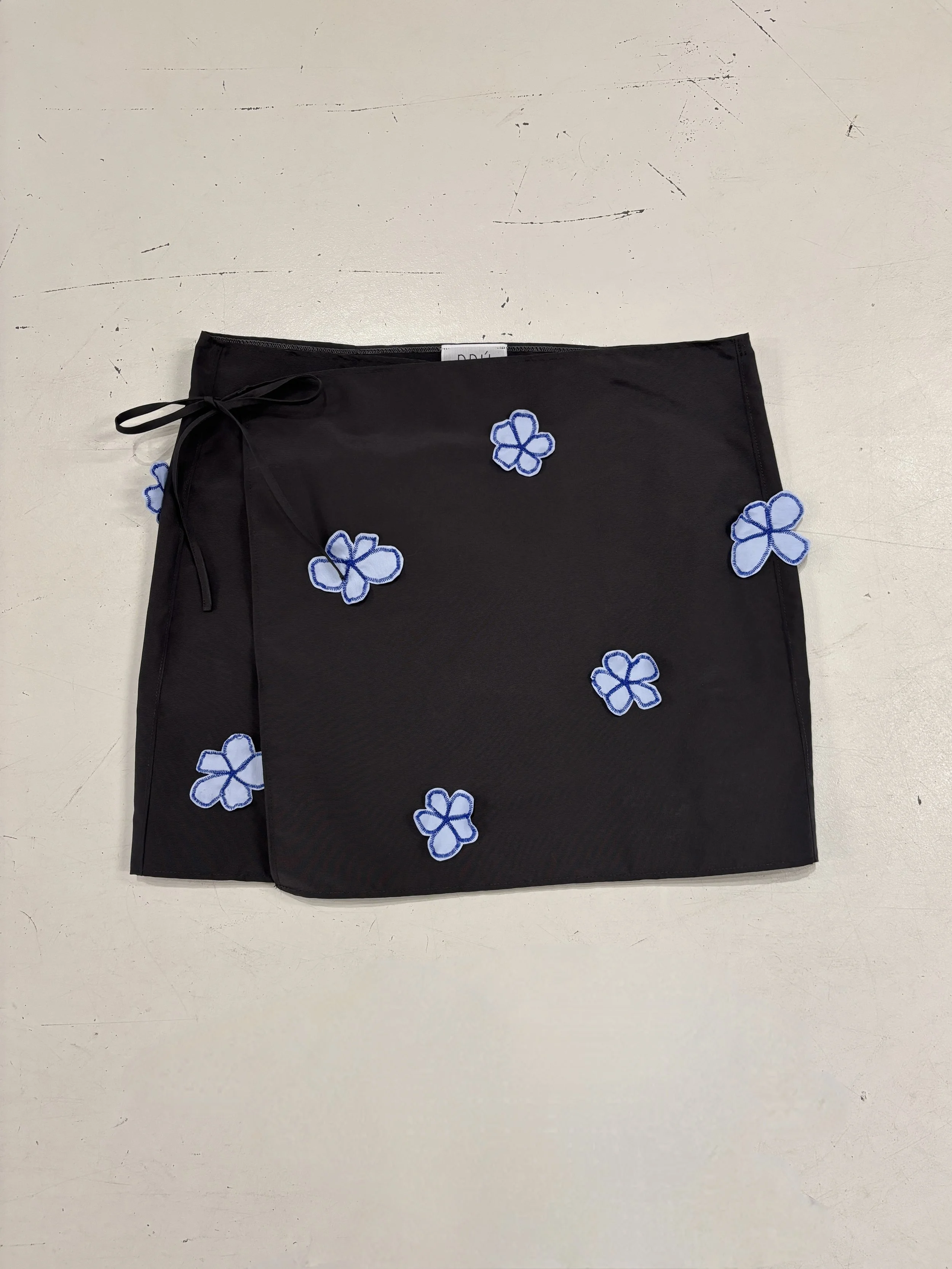 THE SIDE-TIE STATEMENT FLOWER SKIRT