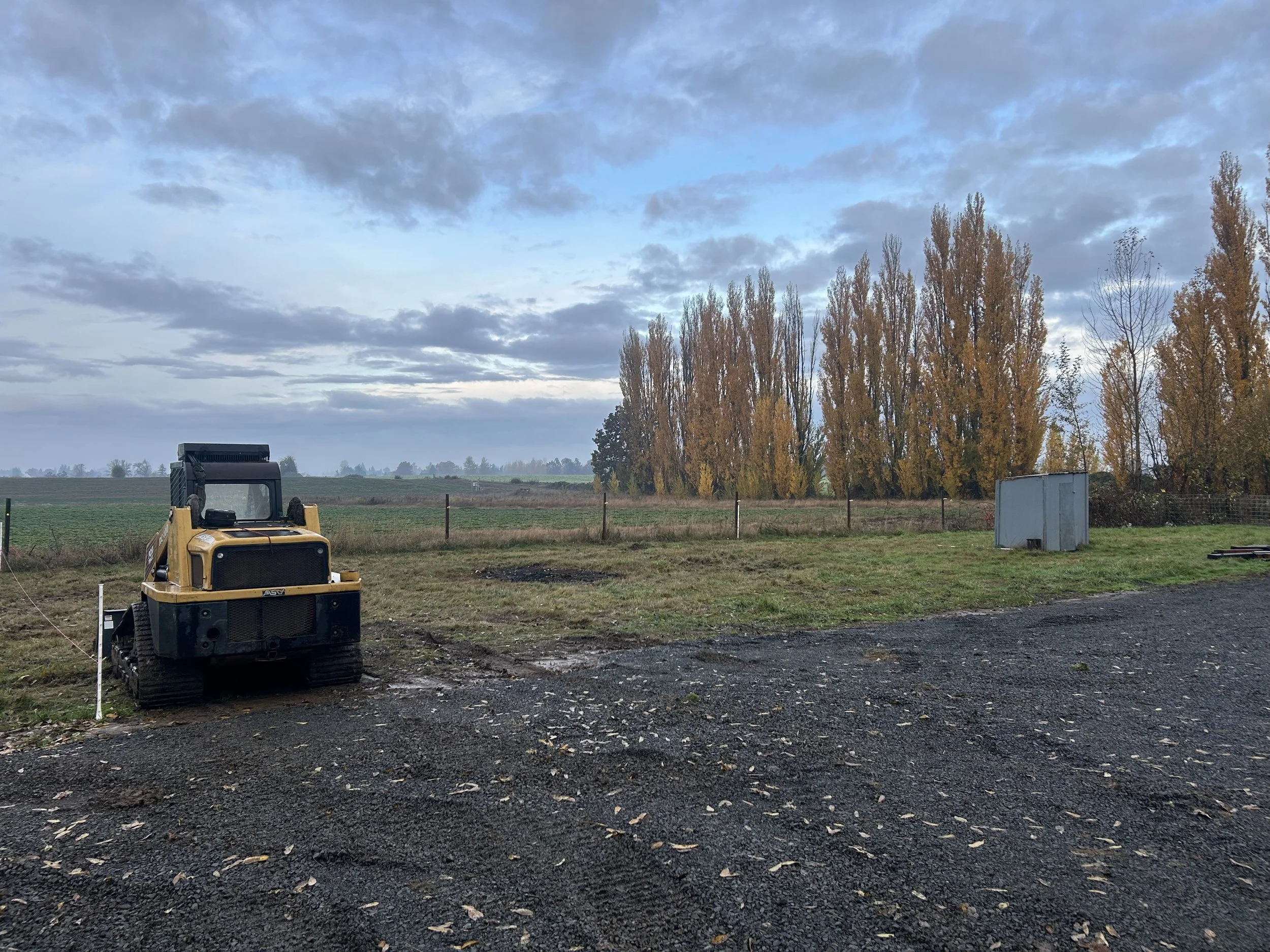 skid steer building a horse arena