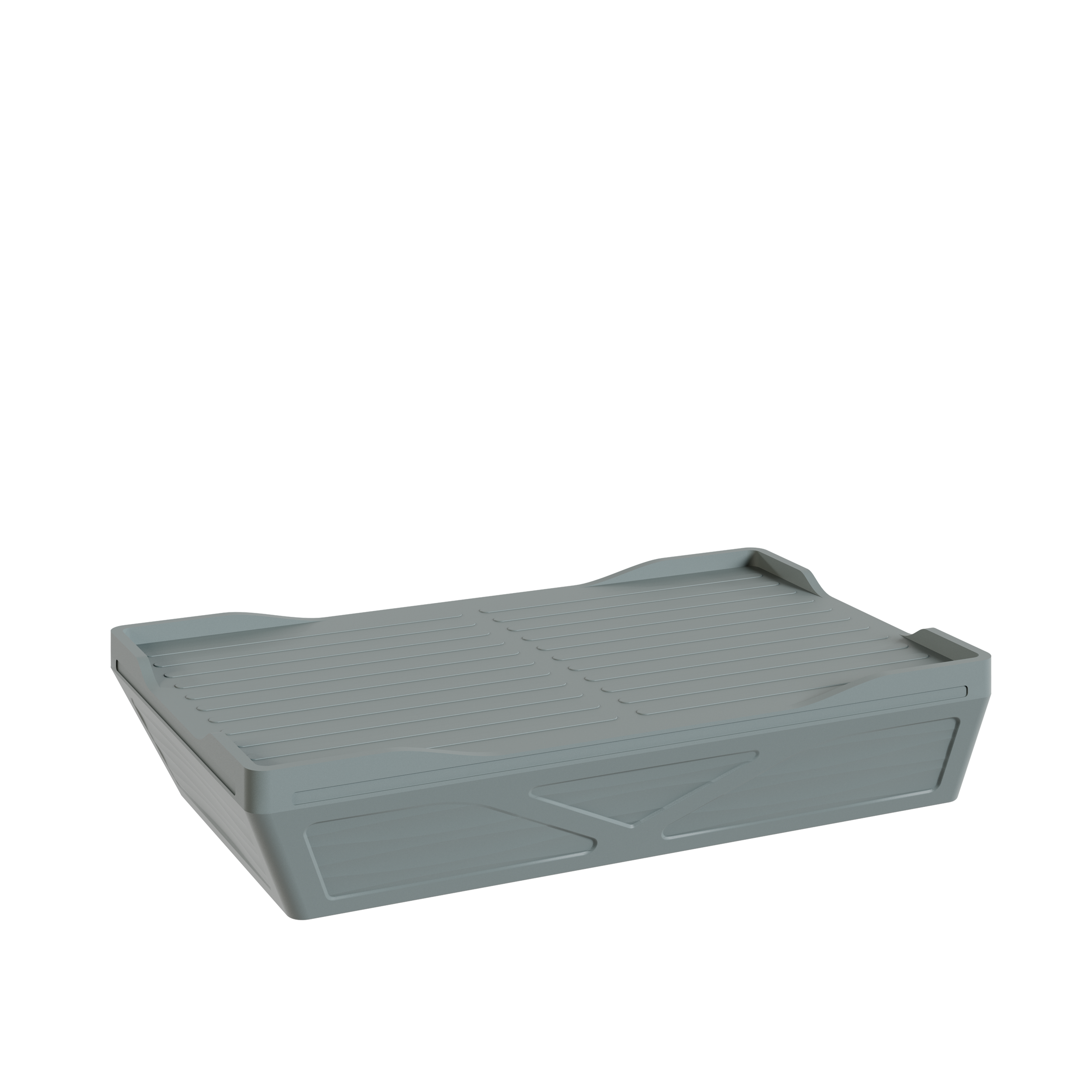 Une porte-revues rectangulaire en plastique gris, avec une surface rainurée, vue de face.