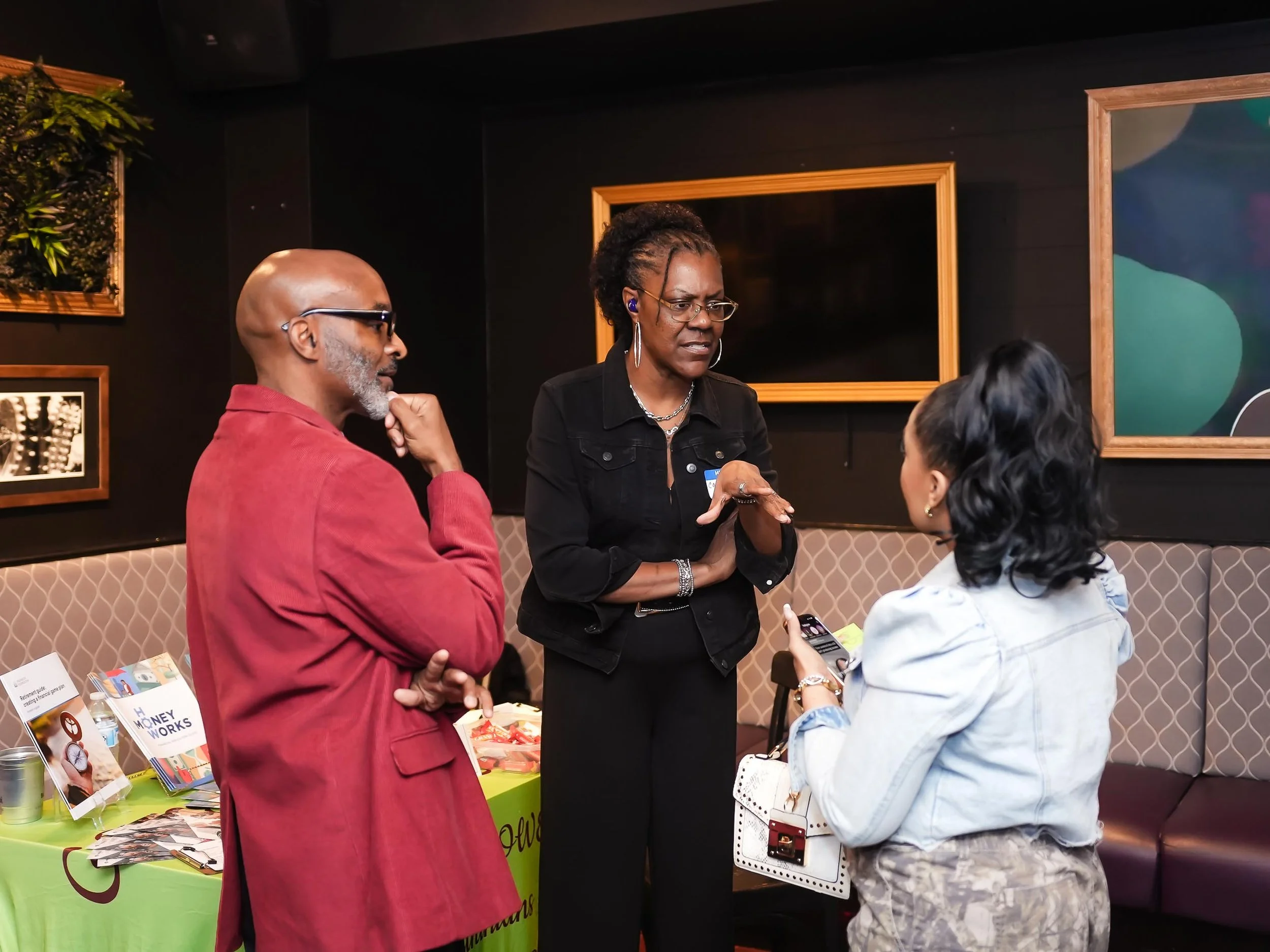 Three Black healers engaging in conversation at the Threshold Social event.