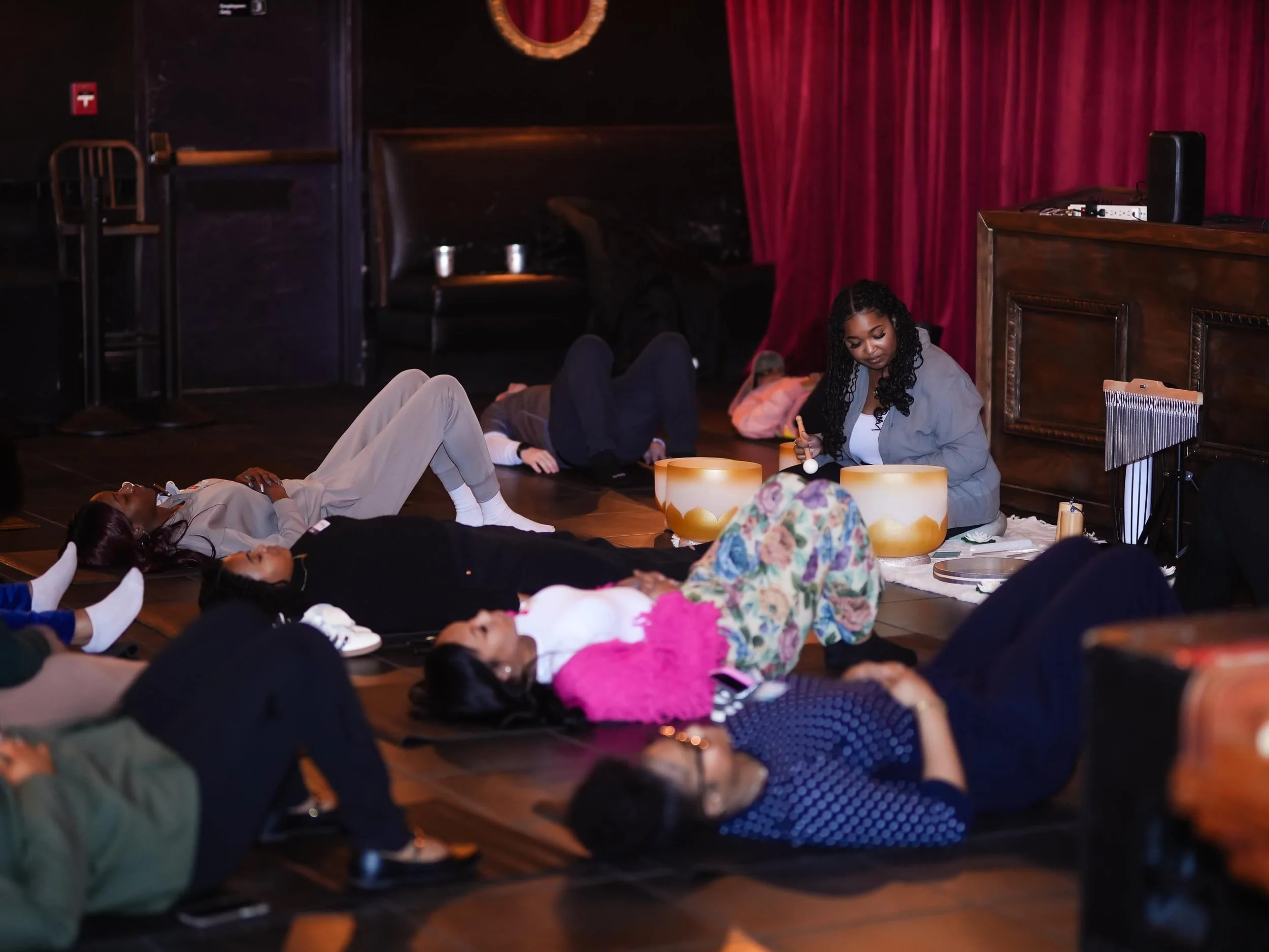 Attendees  during a meditation or relaxation session at the Threshold Social event