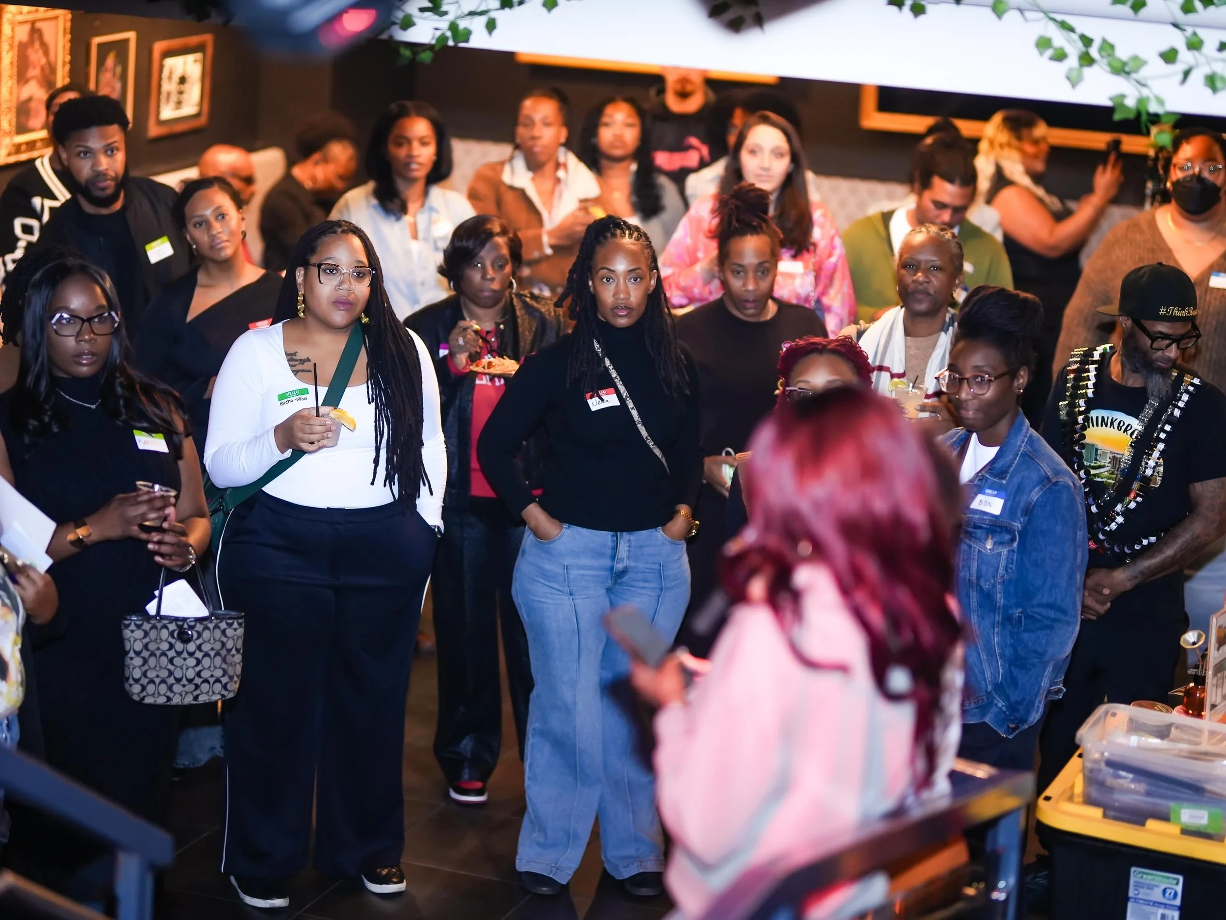 A group of healthcare professionals attending Threshold Social event listening to a speaker.