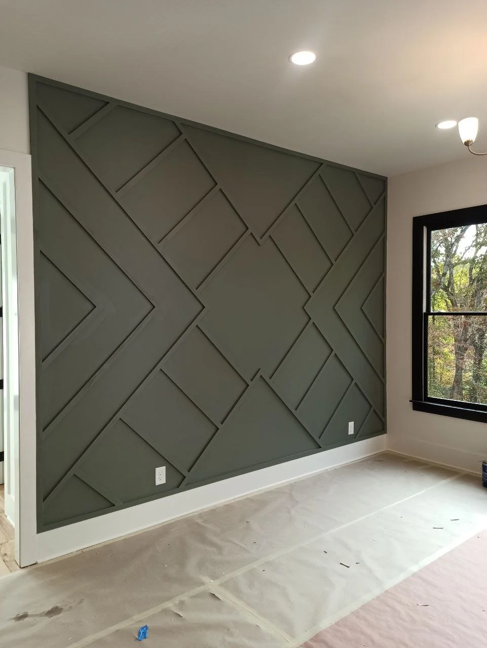 Painting and caulking in progress for modern geometric accent wall in Atlanta, Georgia.