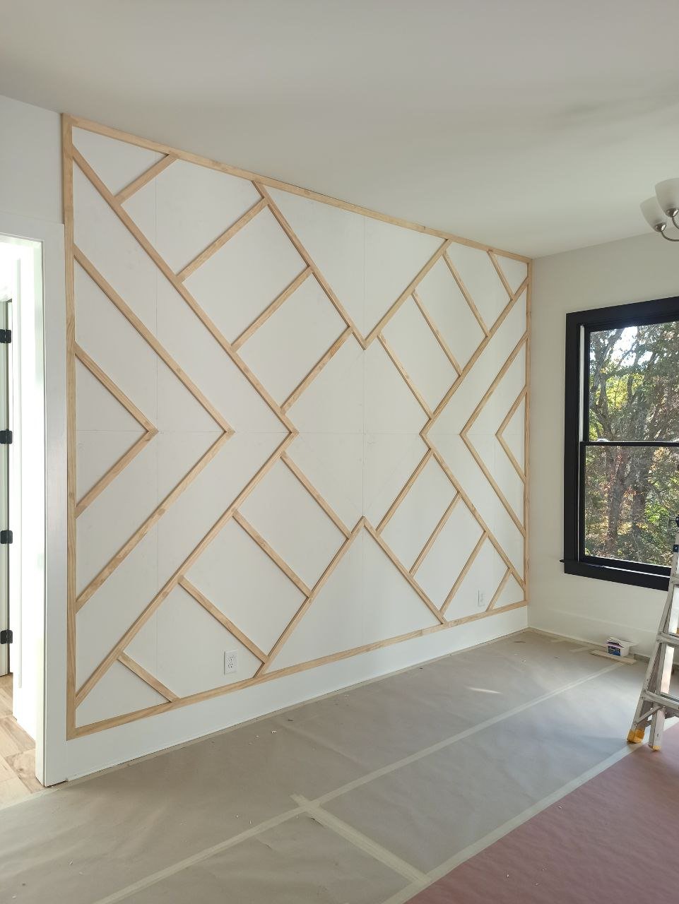 Full geometric board and batten trim layout completed before caulking and painting.
