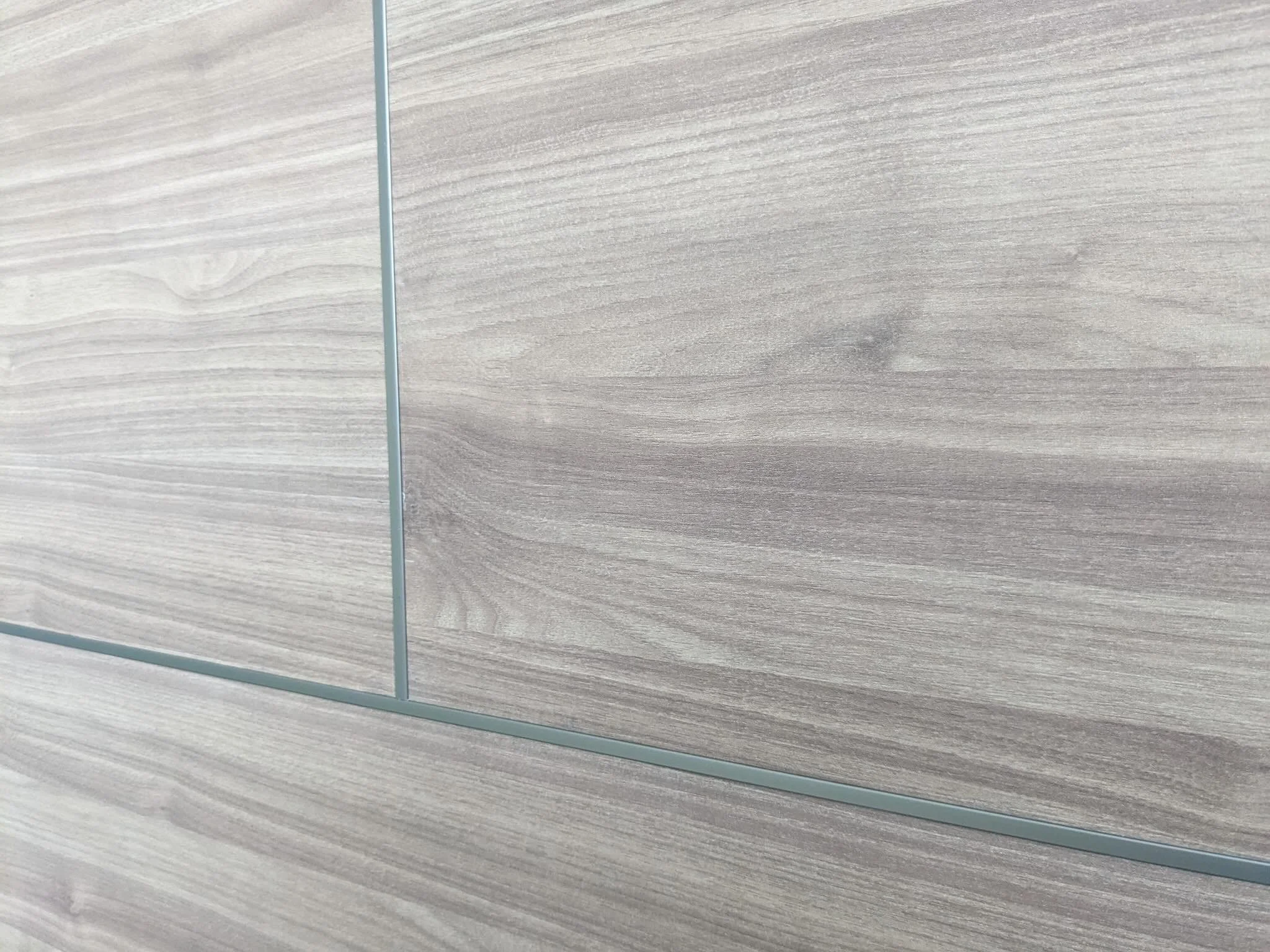 Modern wood panel accent wall in Orlando, Florida.

This project is not only about design.
We built this wall as a future TV media wall from the start.

&bull; Large-format wood panels
&bull; Clean modern layout
&bull; Integrated outlets for TV setup