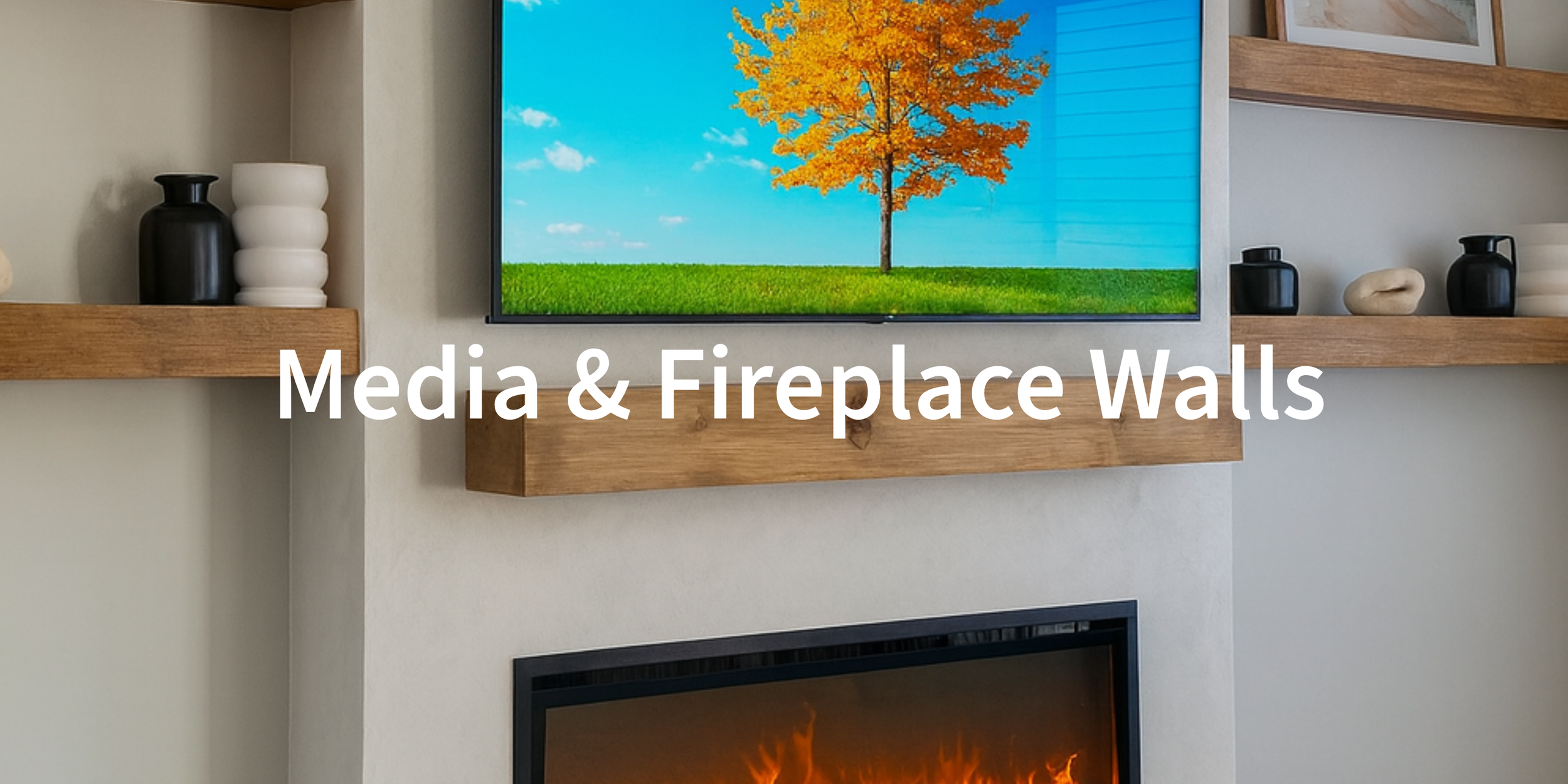 A living room with a wall-mounted flat-screen television displaying a tree with orange leaves in a green field under a blue sky. There are wooden shelves with decorative black and white vases on either side of the TV, and a fireplace below with a glo