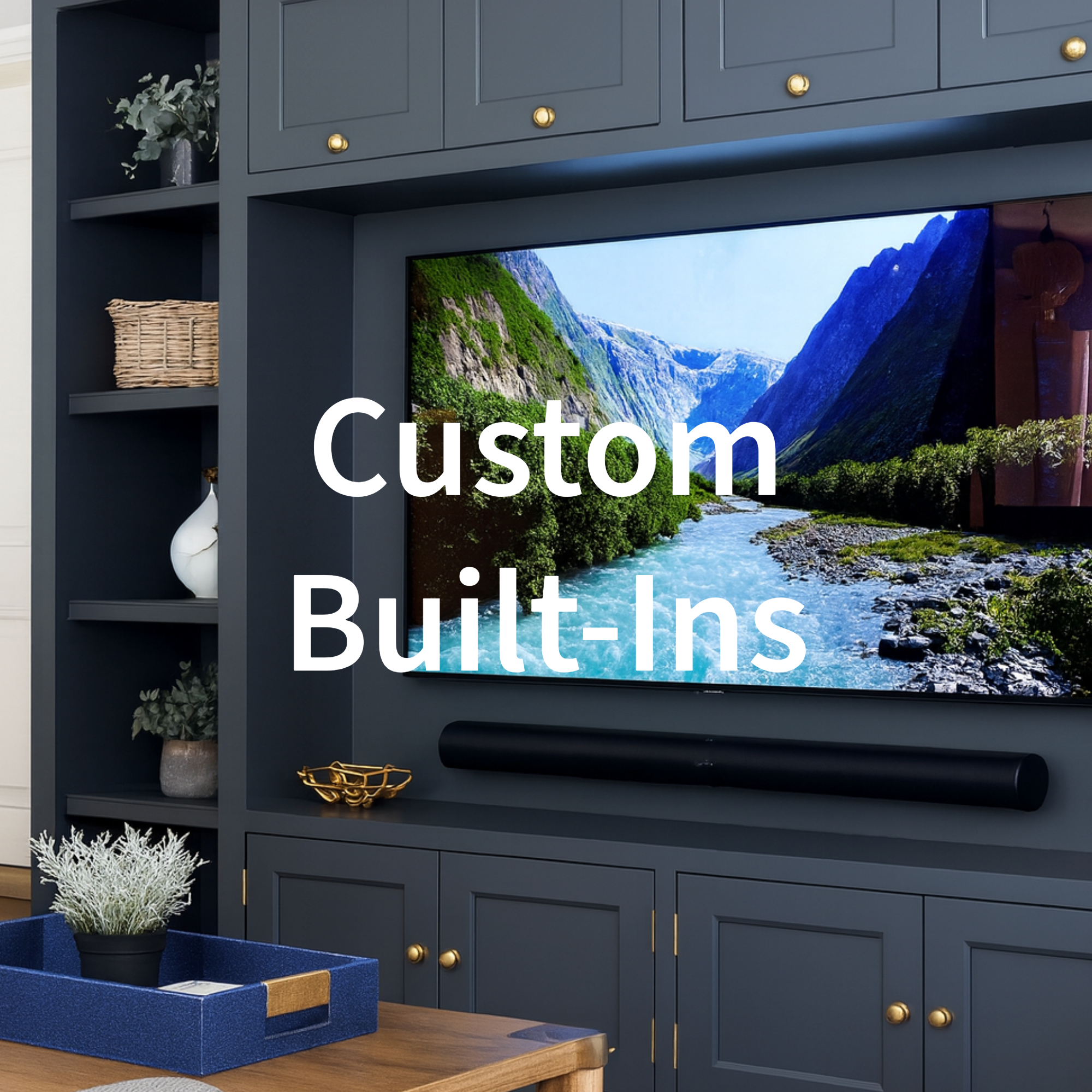 Living room with a large flat-screen TV displaying a mountain and river landscape, built-in dark blue cabinetry with gold knobs, decorative items on shelves, and a table with a blue tray and potted plant in the foreground.