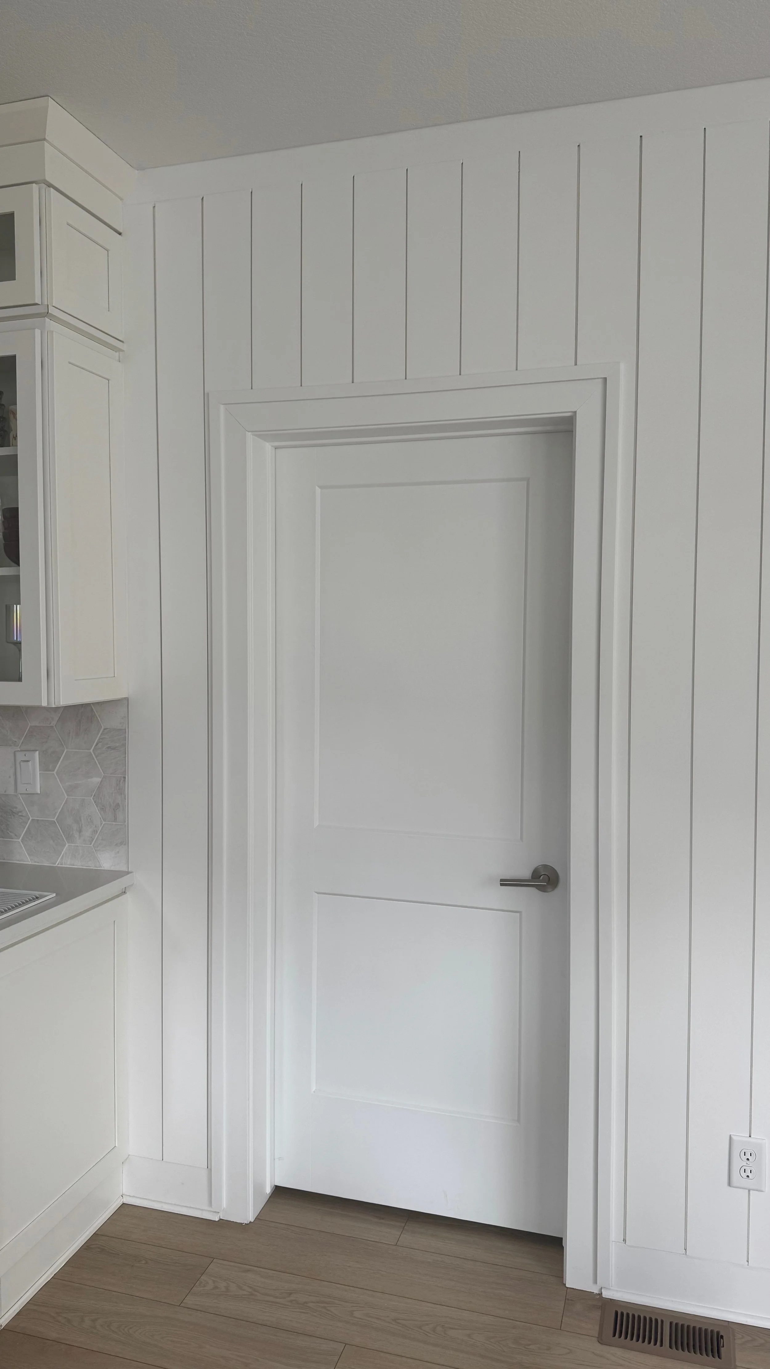 shiplap wall with custom trim around door frame