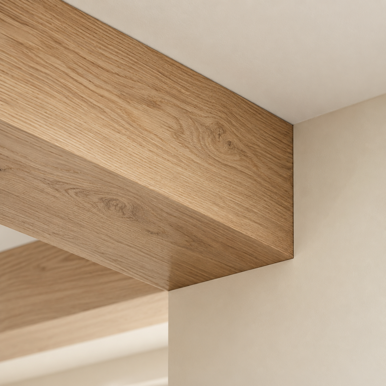 Close-up view of a wooden ceiling corner with a beige wall.