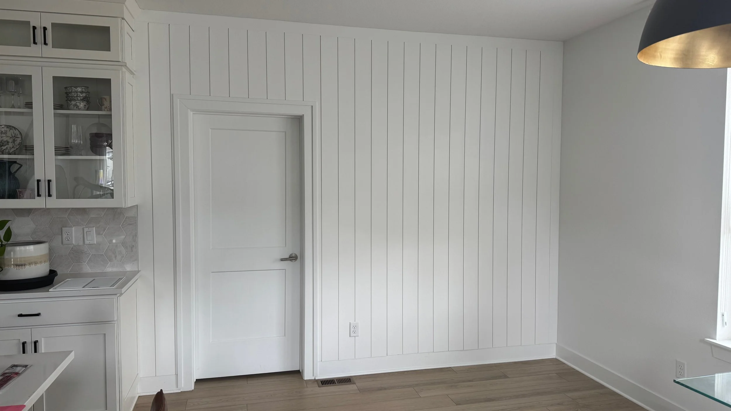 white vertical shiplap accent wall in kitchen dining area tampa