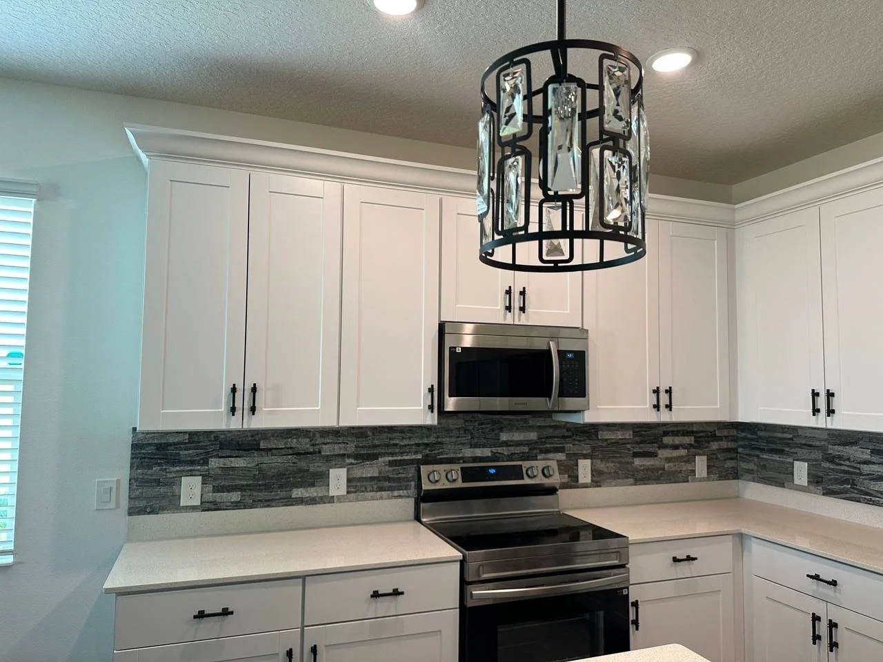 Stone backsplash installed in modern Orlando kitchen.