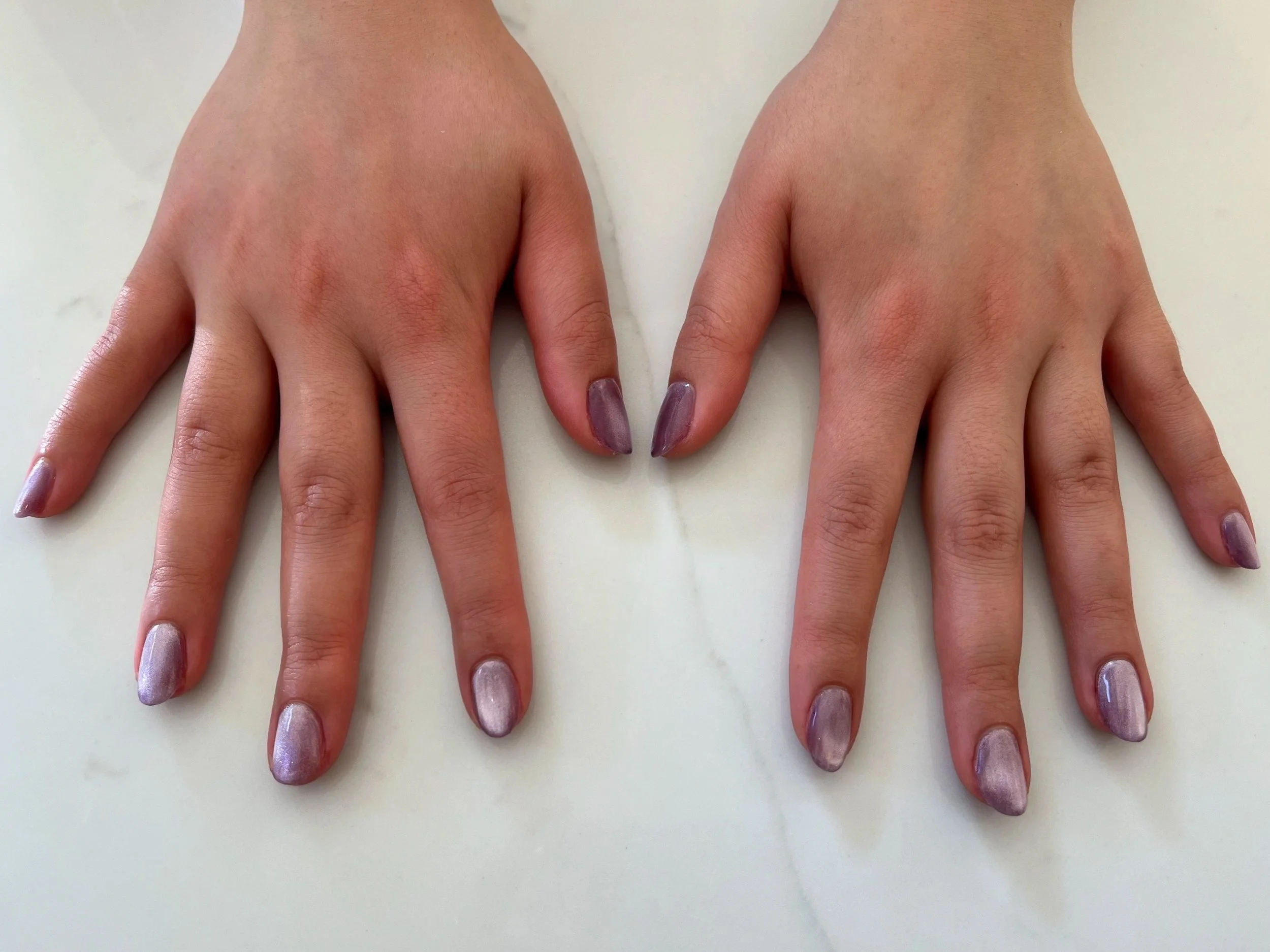 Gel manicure with a lavender cat eye