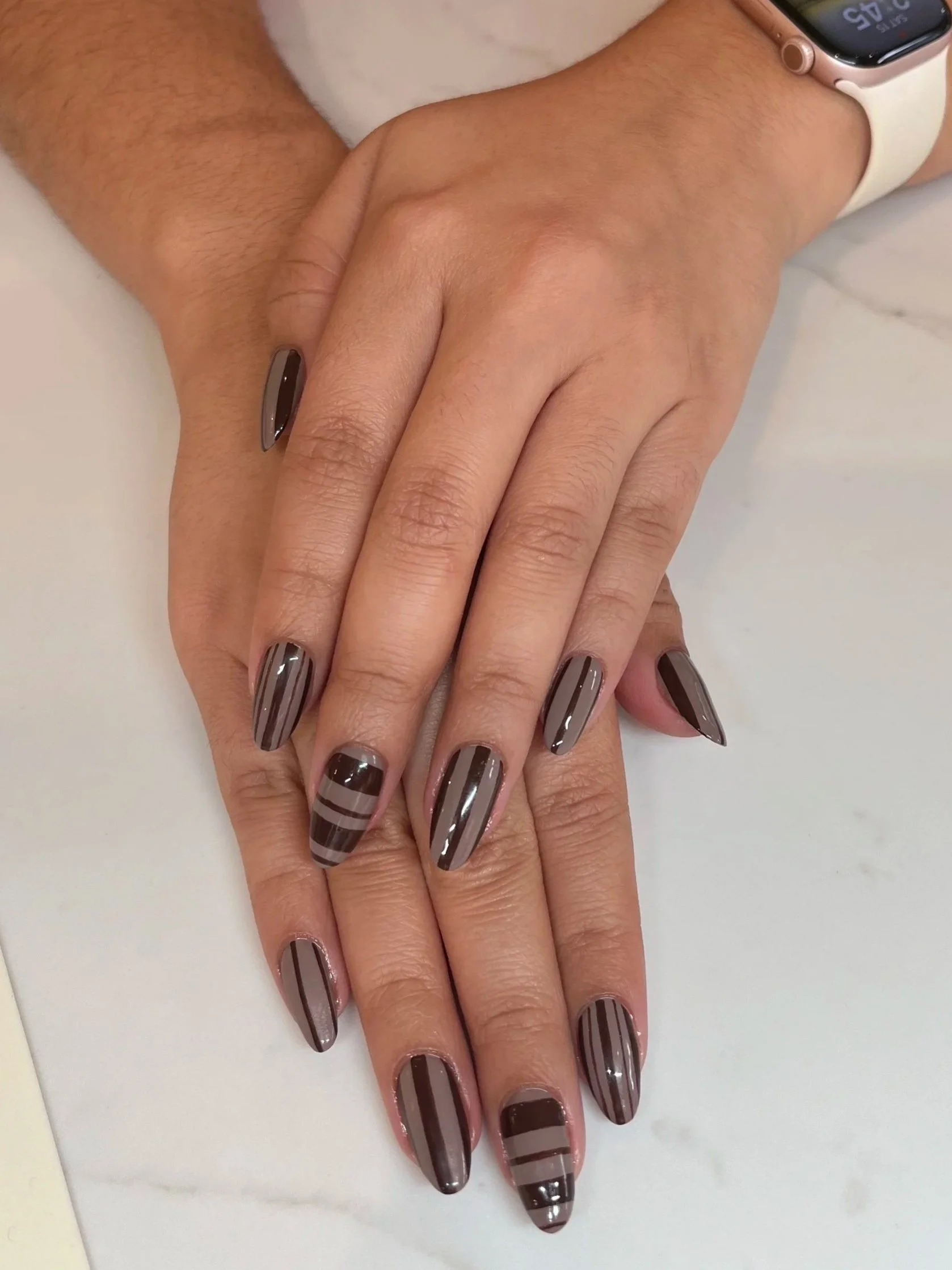 Gel manicure with a grey and black geometric design
