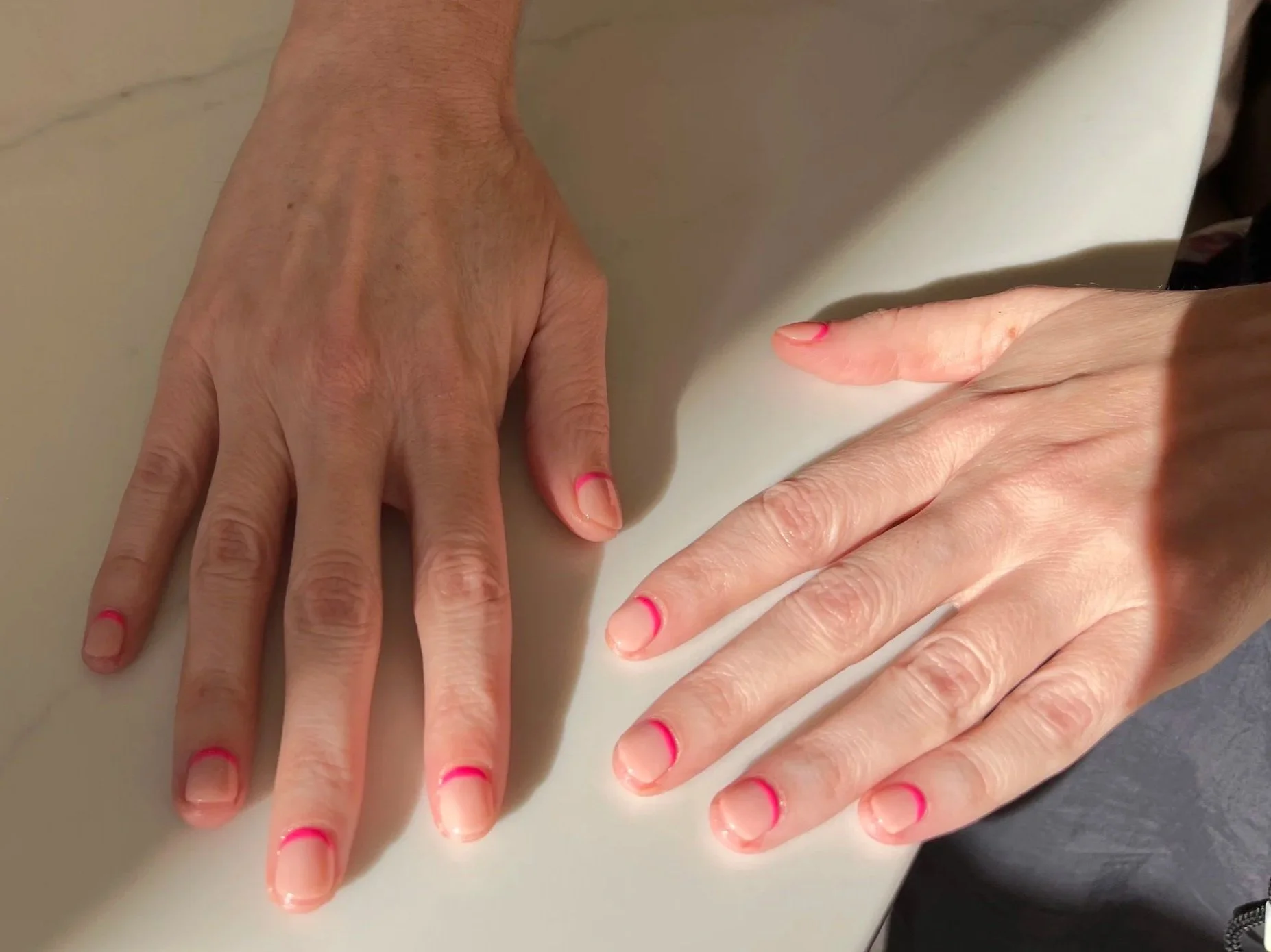 Reverse French tip, using a natural pink and a hot pink polish