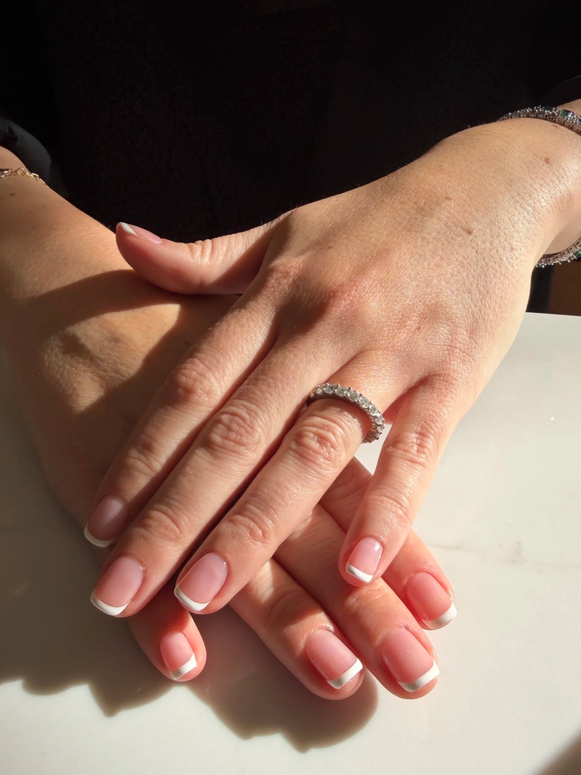 Gel manicure with a sheer natural base and French tip.  Instead of using one universal pink base for our French manicures, we have a variety of "natural colors" to choose from. You can pick a base that best suits you. 