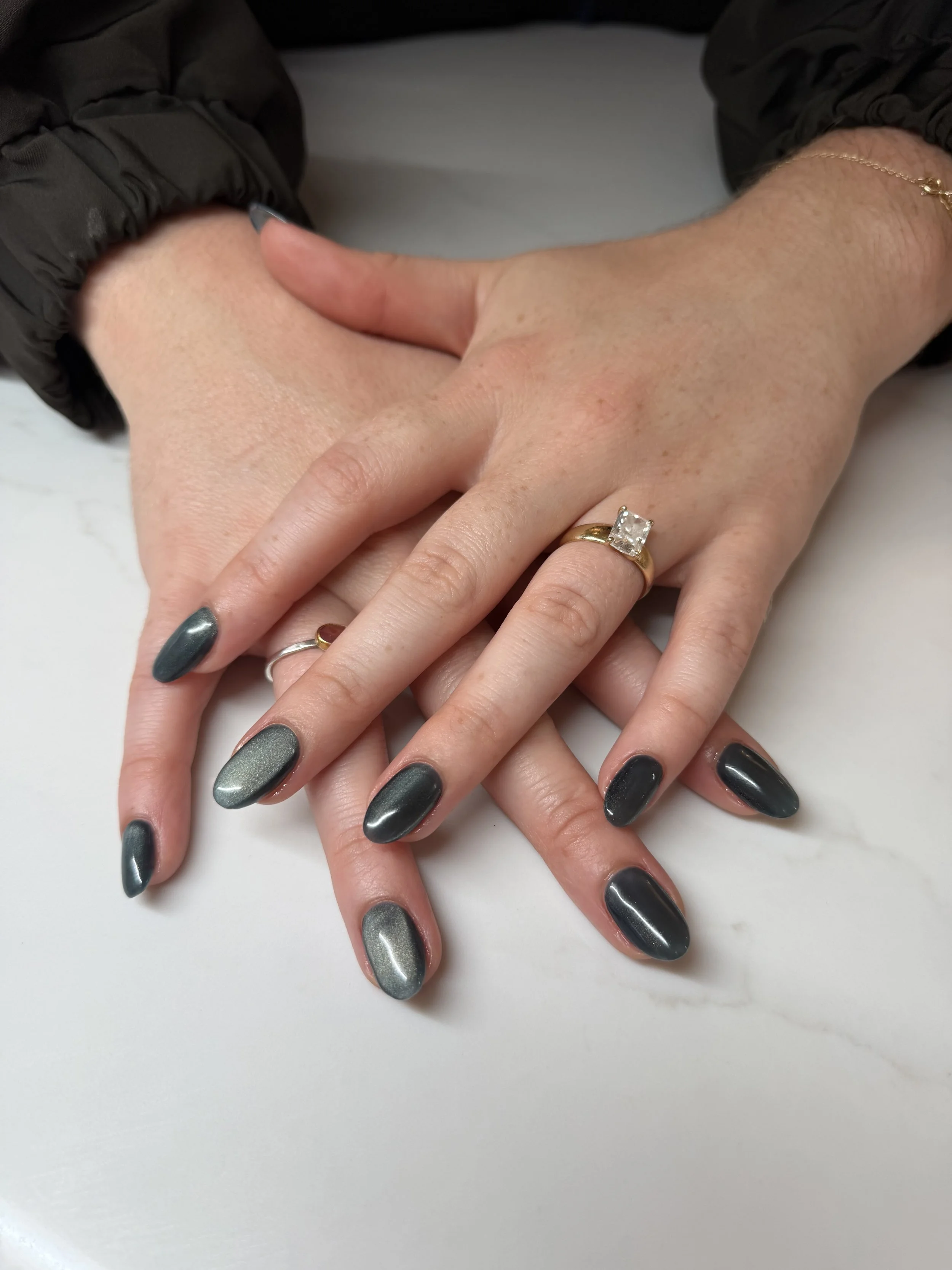 Gel extensions with a navy blue cat eye polish