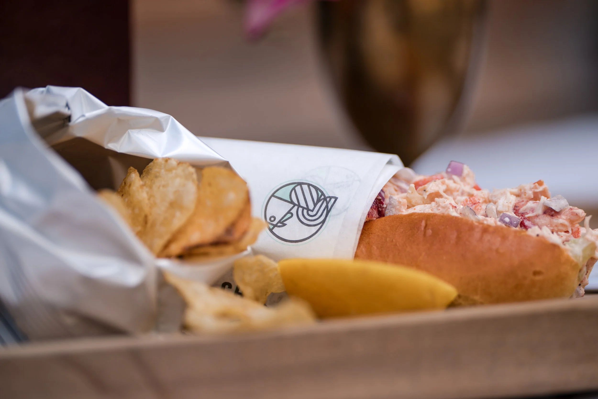 A lobster roll and chips.