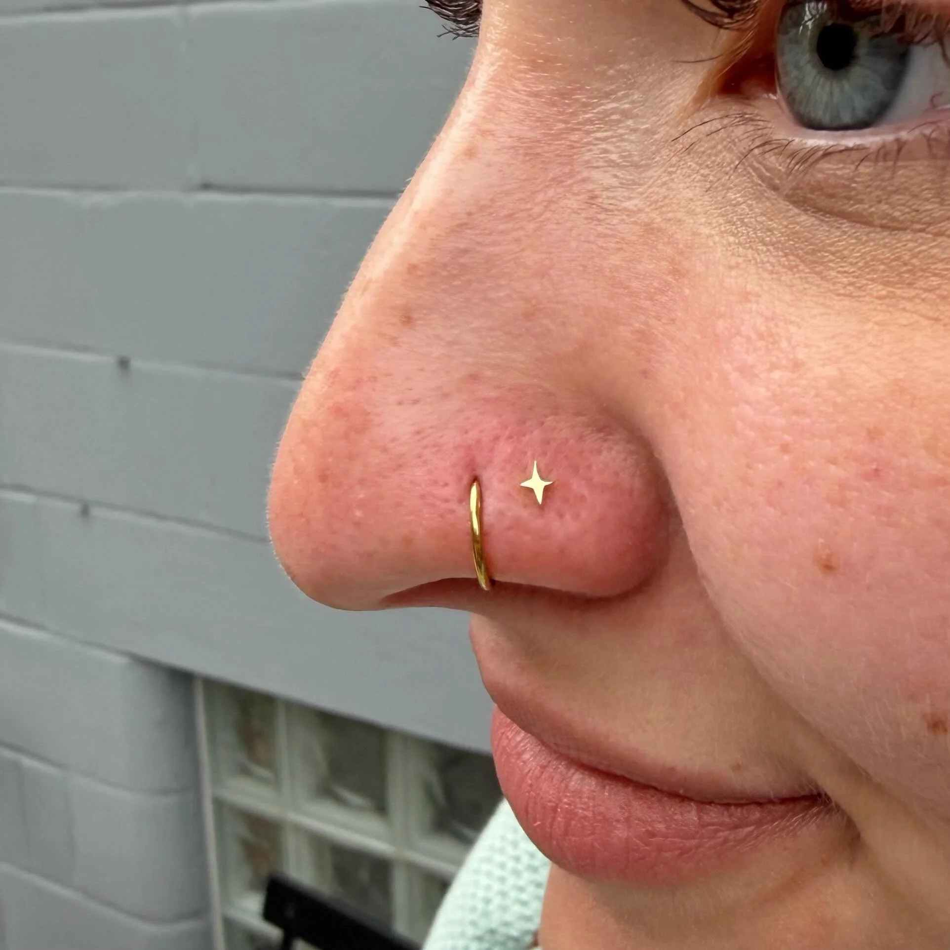 The cutest second nostril piercing using a little gold star from Ember!