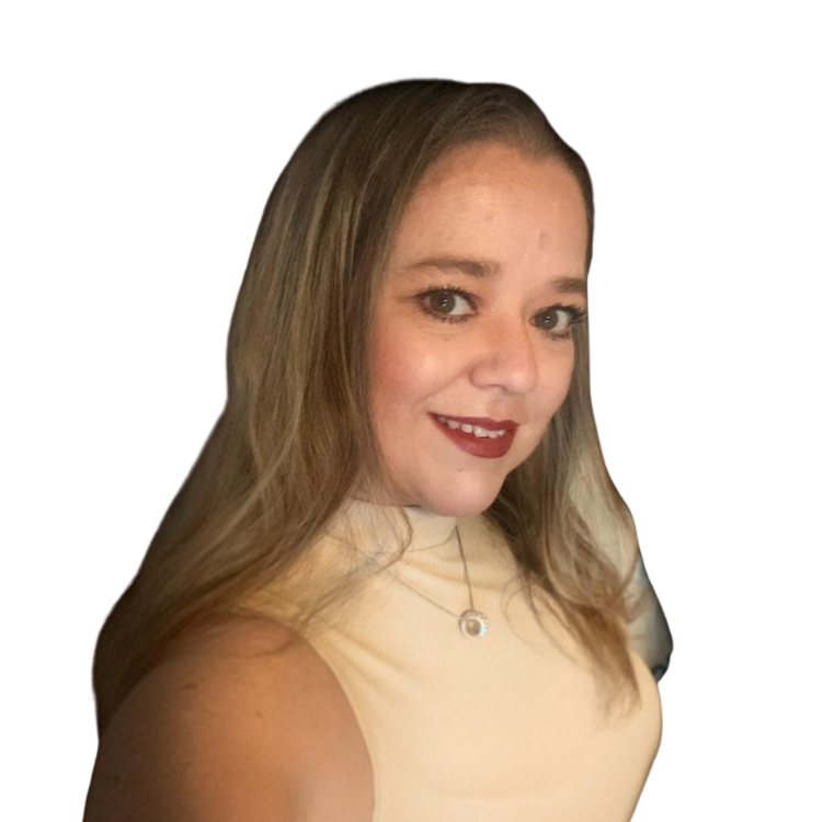 A young woman with long, wavy light brown hair, wearing a sleeveless cream-colored top, pearl necklace with a pendant, and red lipstick, smiling at the camera.
