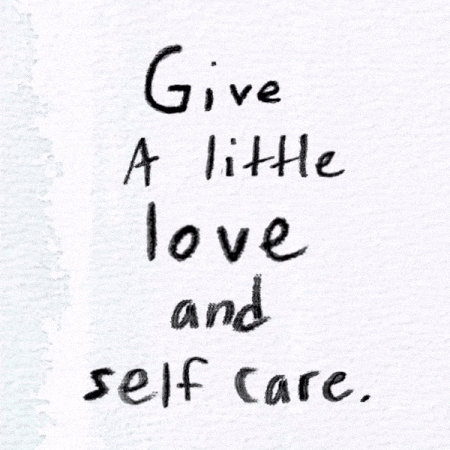 Handwritten quote on white paper that says, 'Give a little love and self care.'