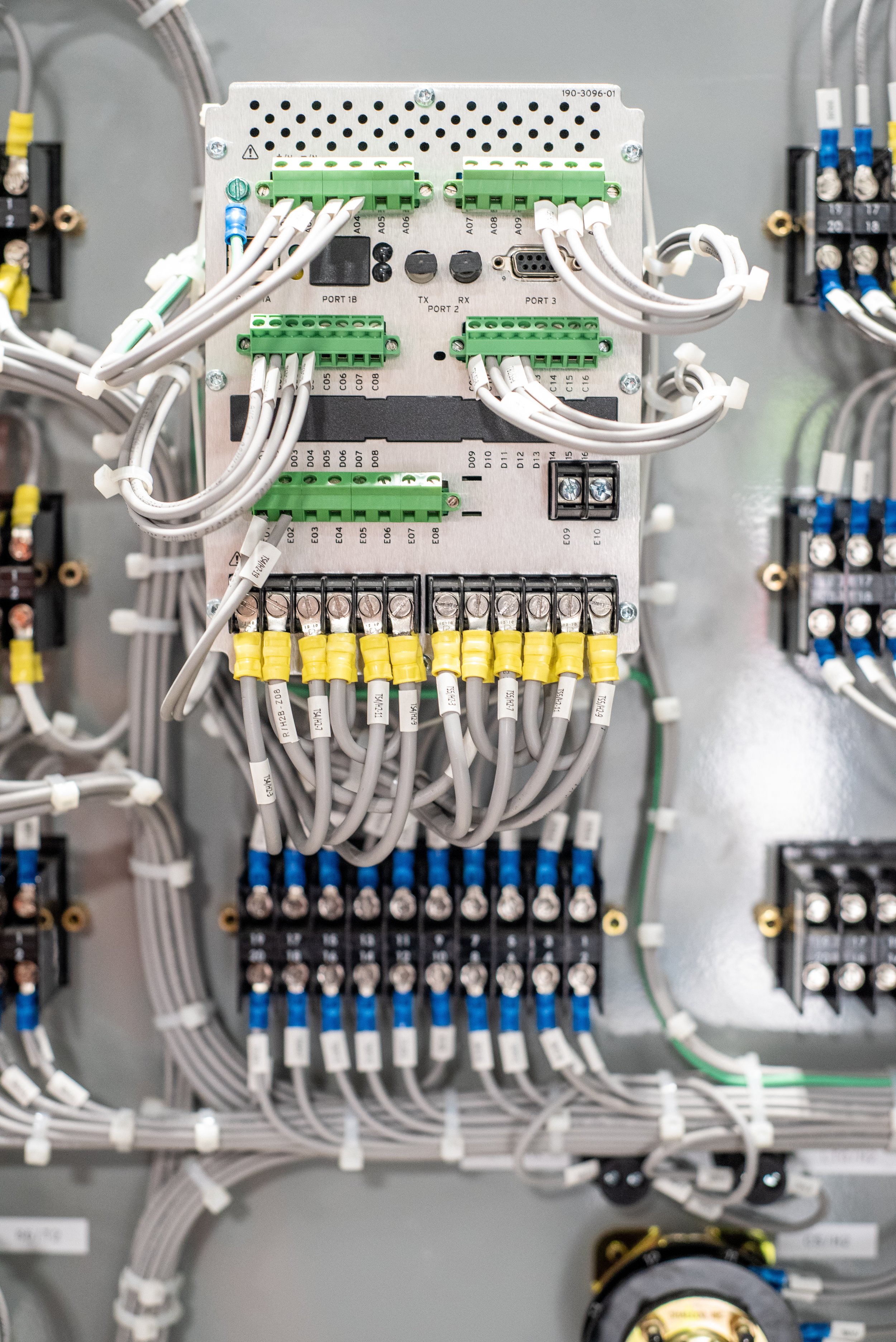 Electrical control panel with various wires, connectors, and components.