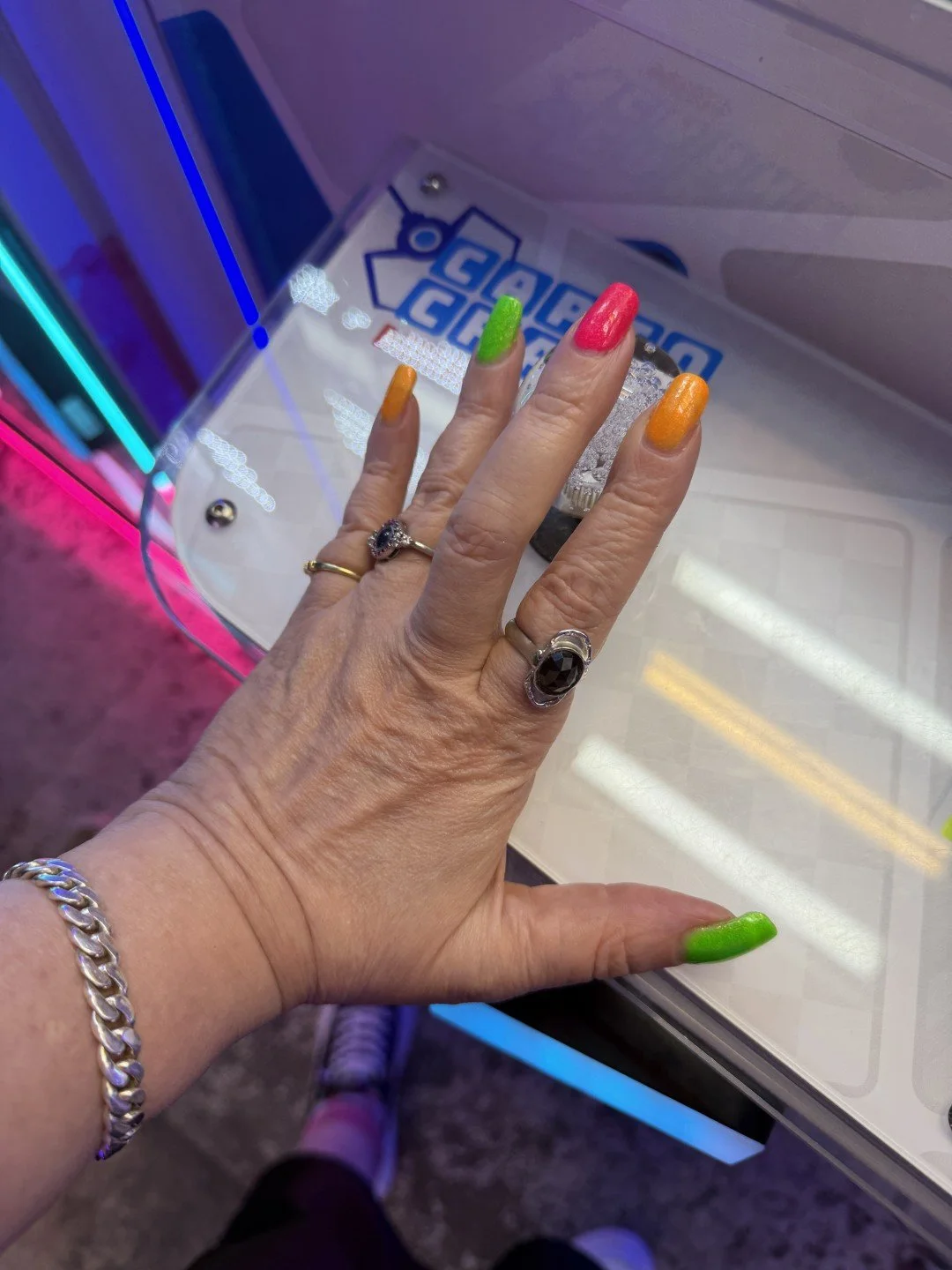 Skittles manicure. Arcade lighting. No notes.

The X-Treme Trifecta is three polishes designed to be worn together, separately, or in whatever chaotic combination your heart demands. Solar Storm (orange), Optic Blast (green), and Omega Dazzler (pink)