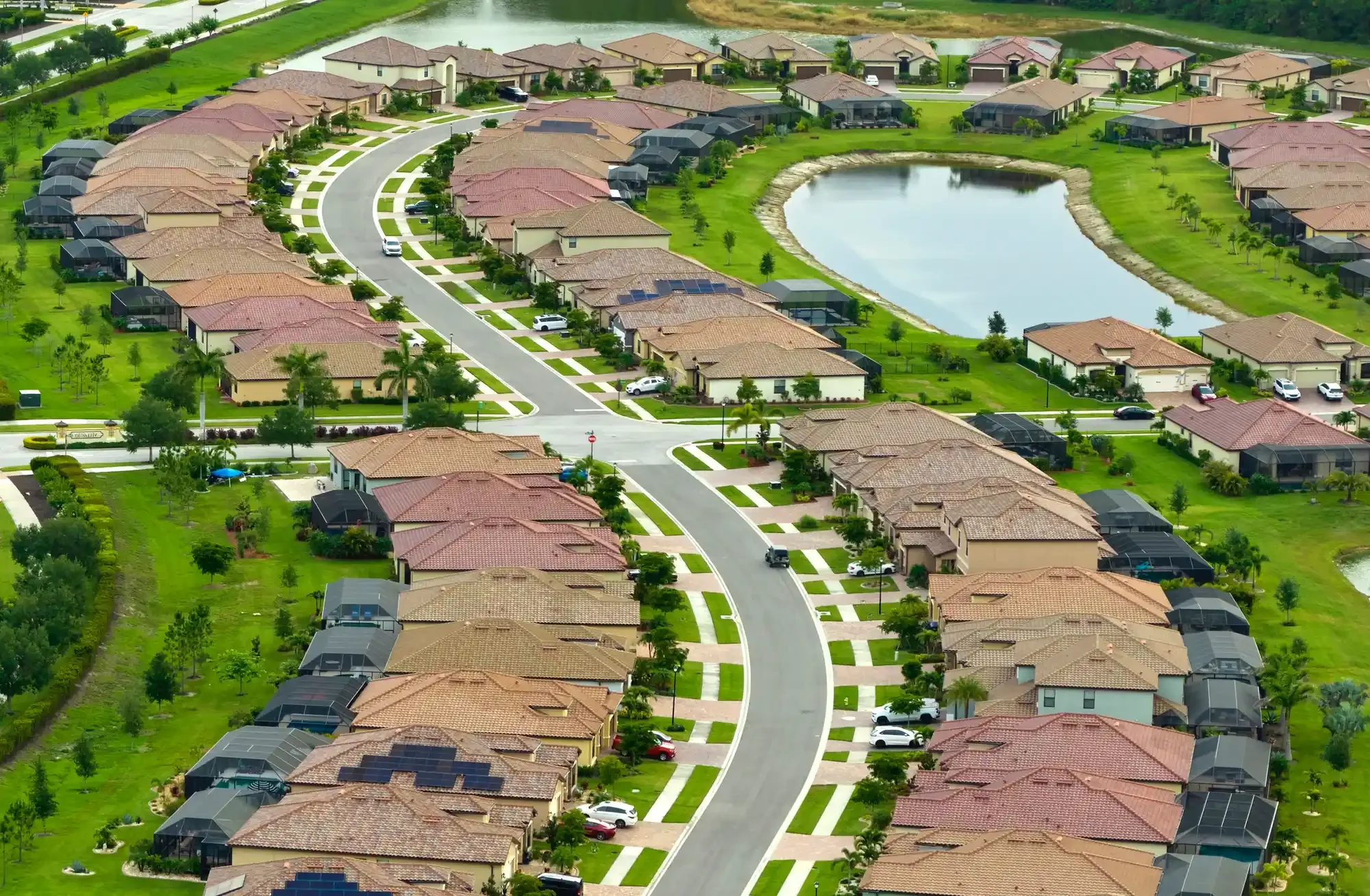 Aerial view of a Florida HOA Development with residential houses with pool screen and lanai enclosures
