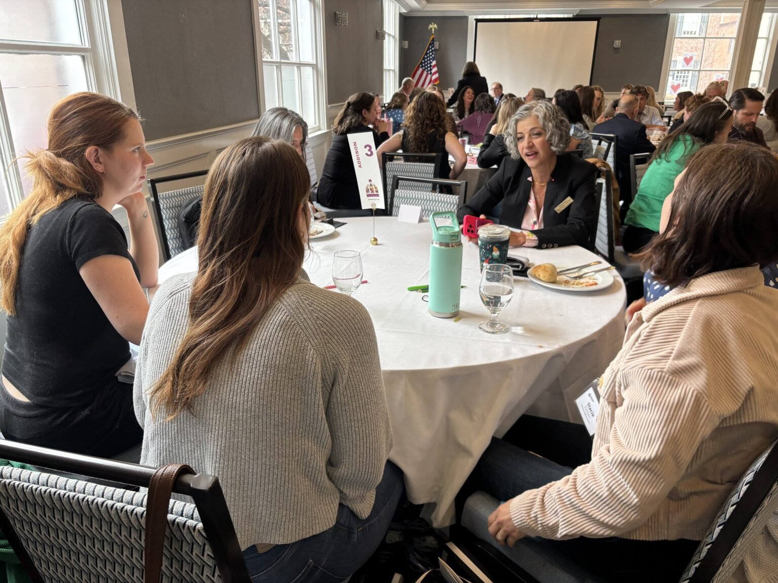 women sitting at a table having a conversation