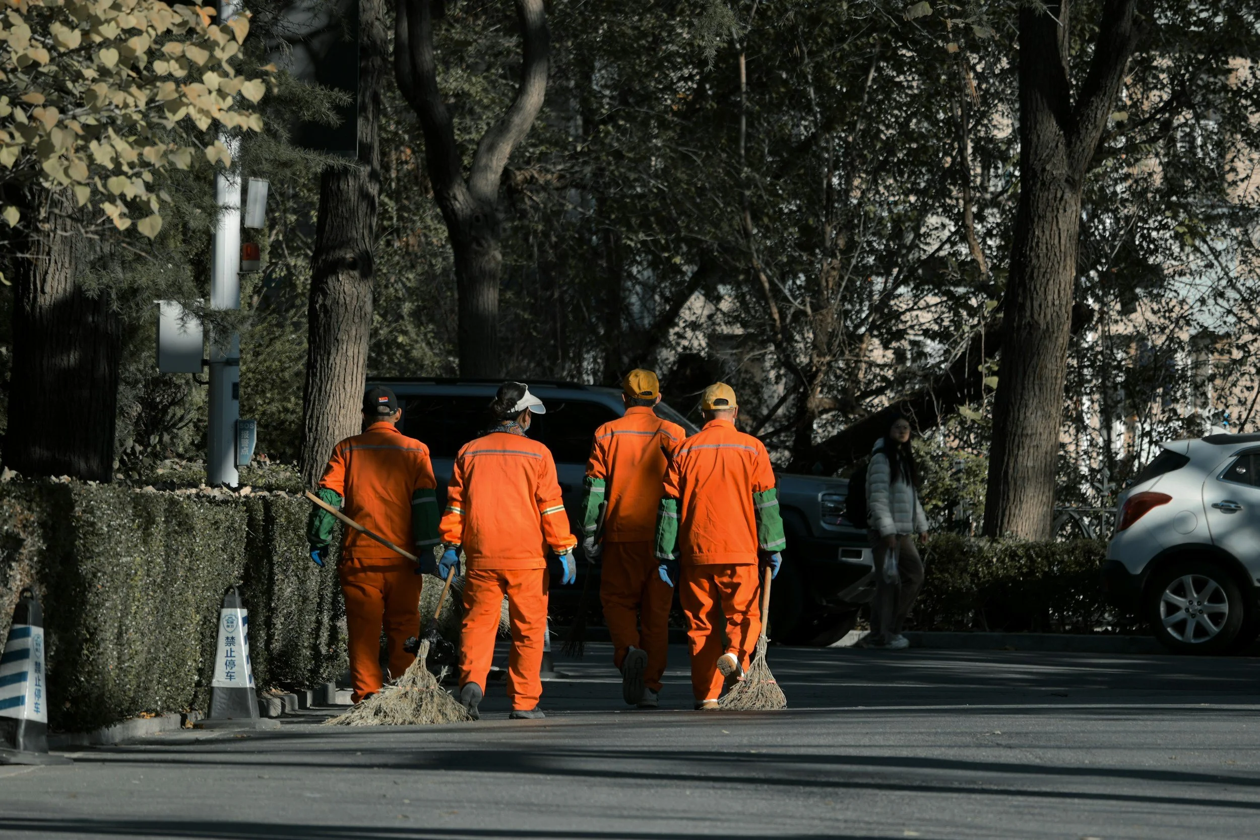 People in jumpsuits working on a road