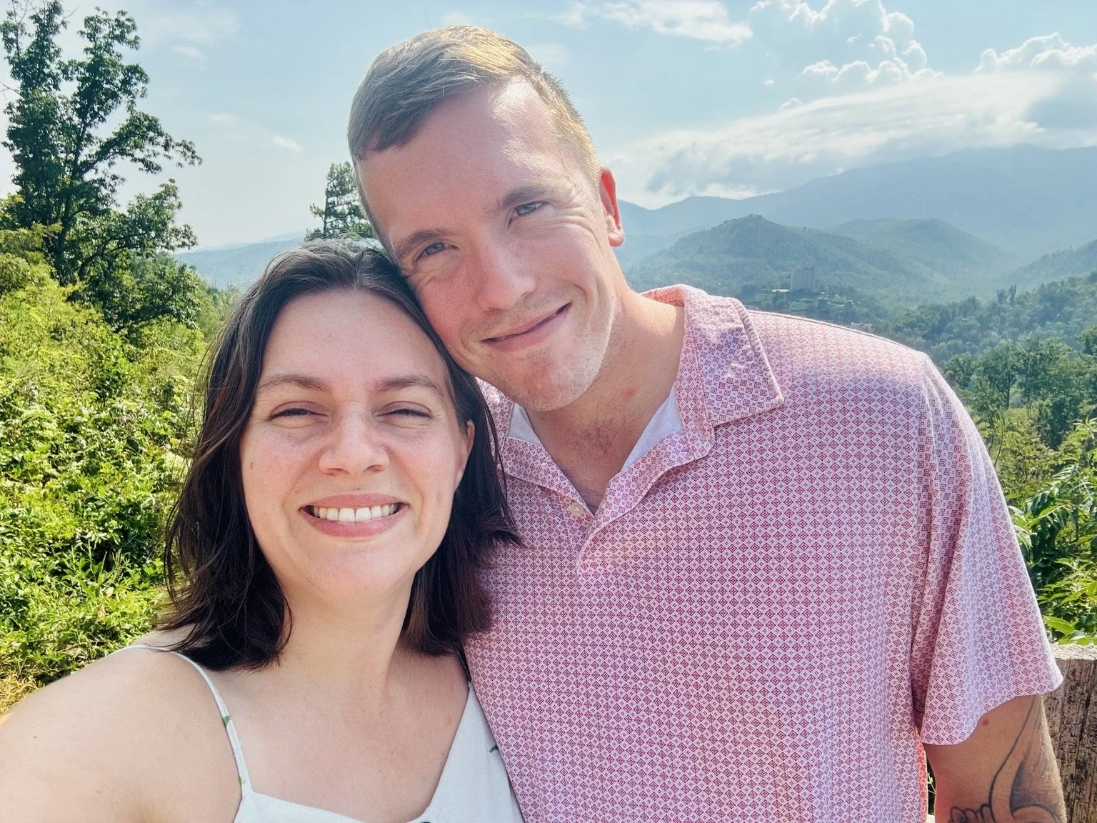 Jeremy and Jade Groves smiling together outdoors.